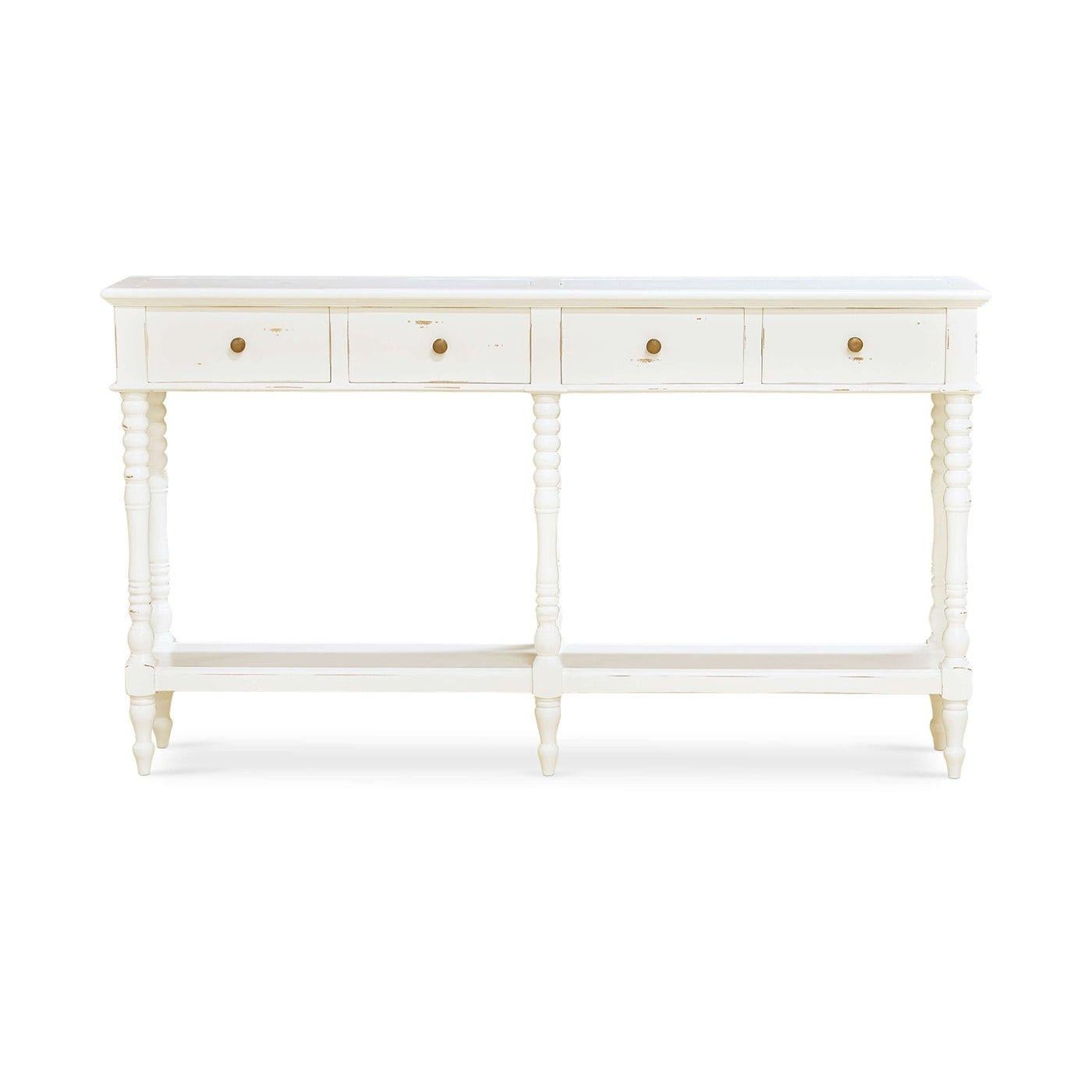 Designed to add sophistication and functionality, this table features beautifully turned legs and four frieze drawers, providing ample storage for your essentials. The lightly distressed white finish gives it a warm, vintage appeal, perfect for