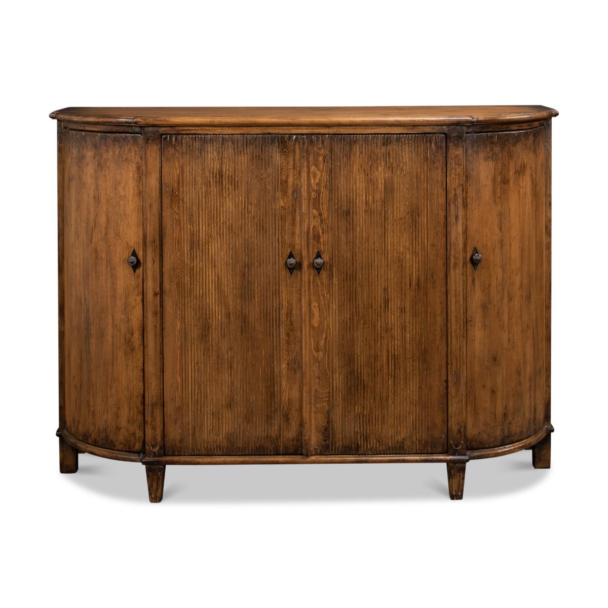 French Country Demilune cabinet with a rustic warm polished finish on pine with curved doors to the sides and two reeded center doors, each section fitted with shelves. 

Dimensions: 63