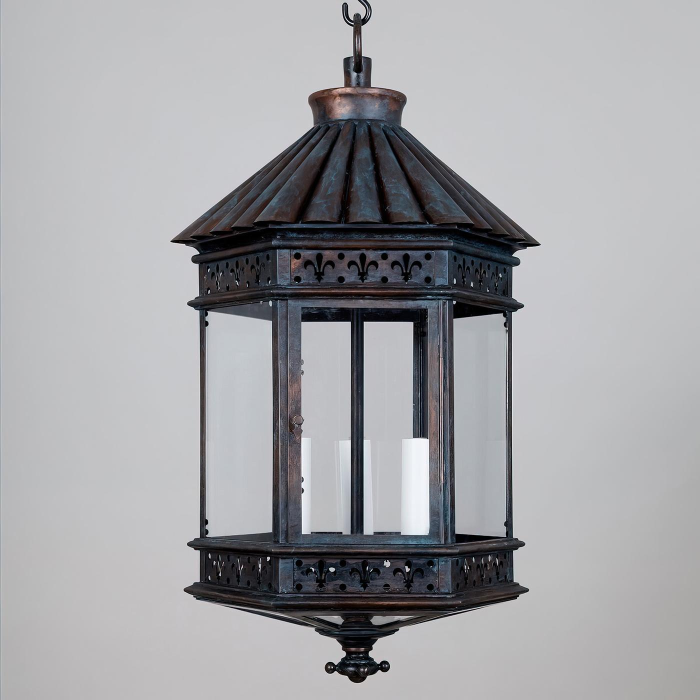 French Country Lantern, This hexagonal lantern has a fluted lotus roof, fleur de lis reticulated panel sides, glass sides and door with three lights.

The copper bronze finish adds to the elegance of the lantern. UL Listed for wet locations.