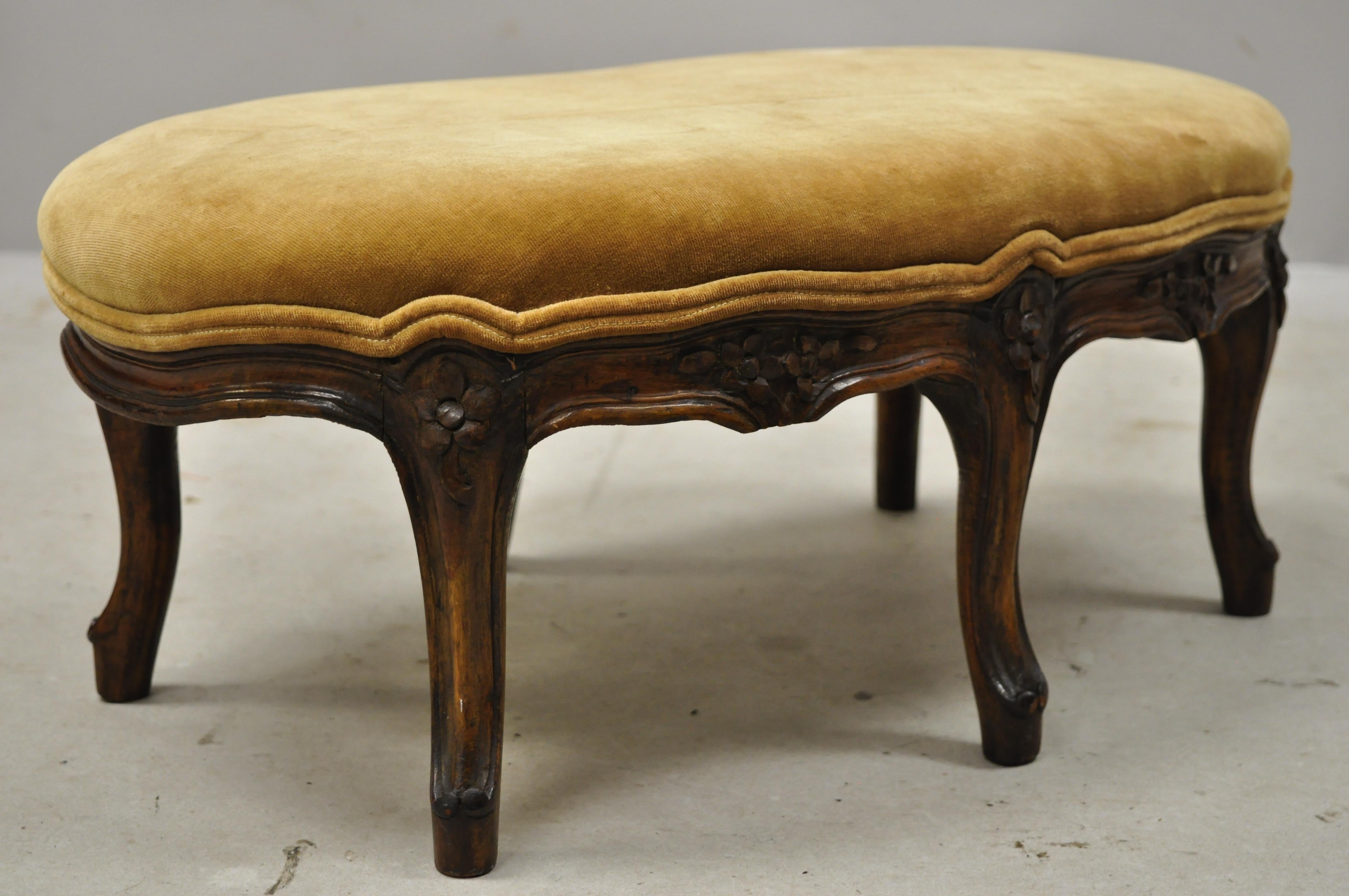 Antique French country Louis XV Provincial walnut small petite oval footstool ottoman. Item features a nice oval size, solid wood frame, nicely carved details, 6 cabriole legs, very nice antique item, circa early 1900s. Measurements: 9.5