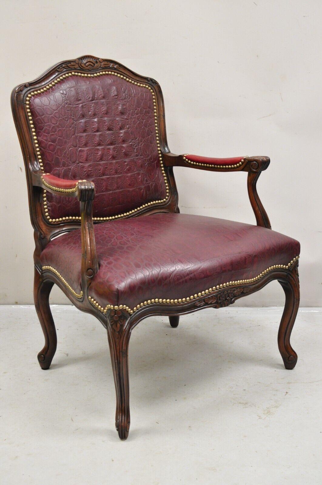 French Country Louis XV Style Burgundy Leather Faux Reptile Cowhide Armchair. Item features a distressed solid wood frame, burgundy leather embossed reptile print upholstery, brown cowhide upholstery to rear panel. Circa Late 20th Century.