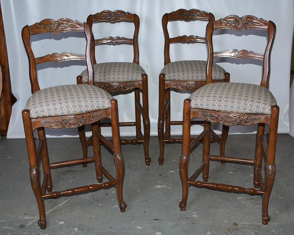 Set of 4 Louis XV French provincial country style bar or kitchen counter stools. Stools feature solid carved wood frames, upholstered inset seat cushions, ladder backs and cabriole legs. Seat height - 27