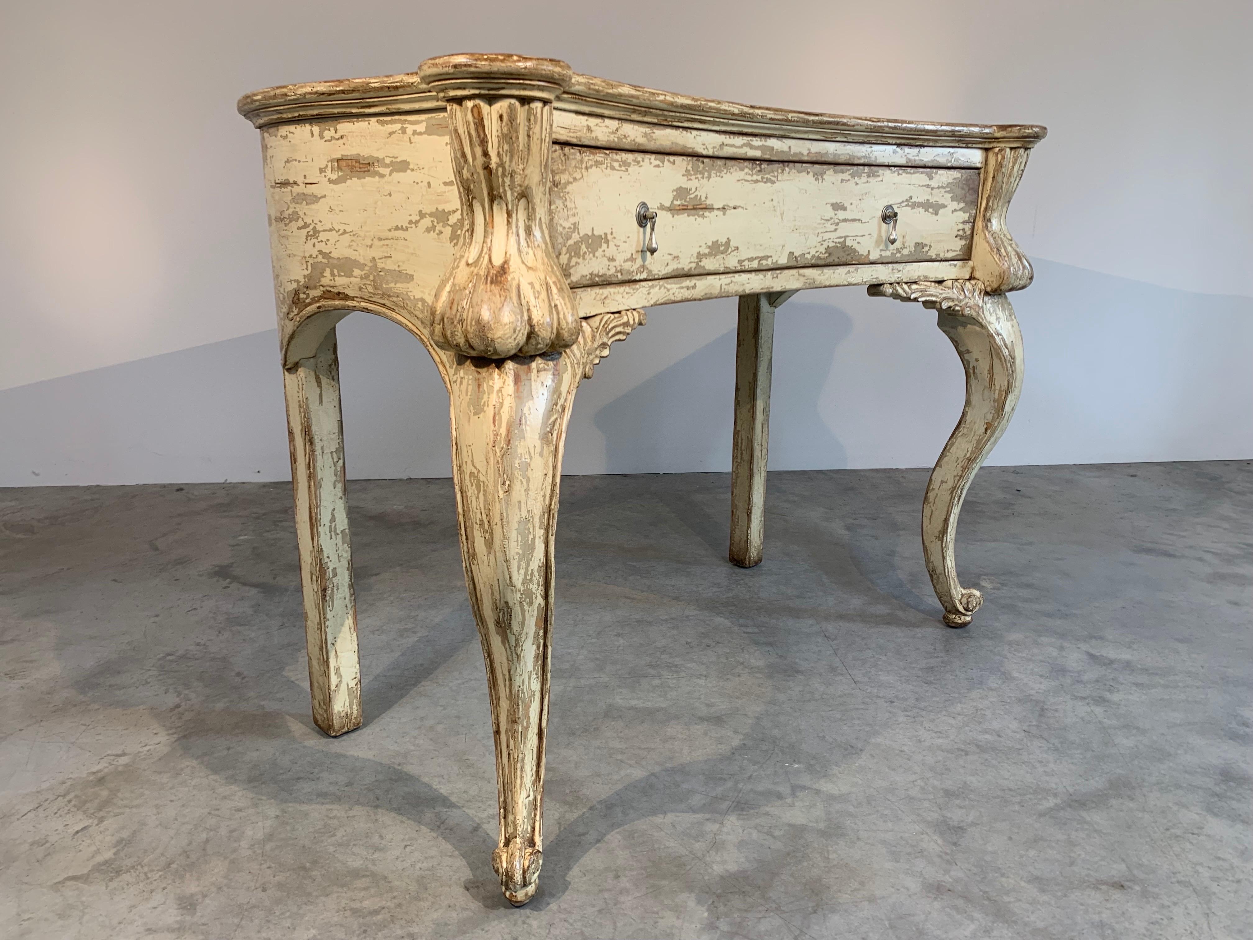 A bold and attractive console table in the Country French style having distressed finish by Woodland Furniture Company. Very high quality and in outstanding condition. 
 Can be used as a console, entryway table or desk.