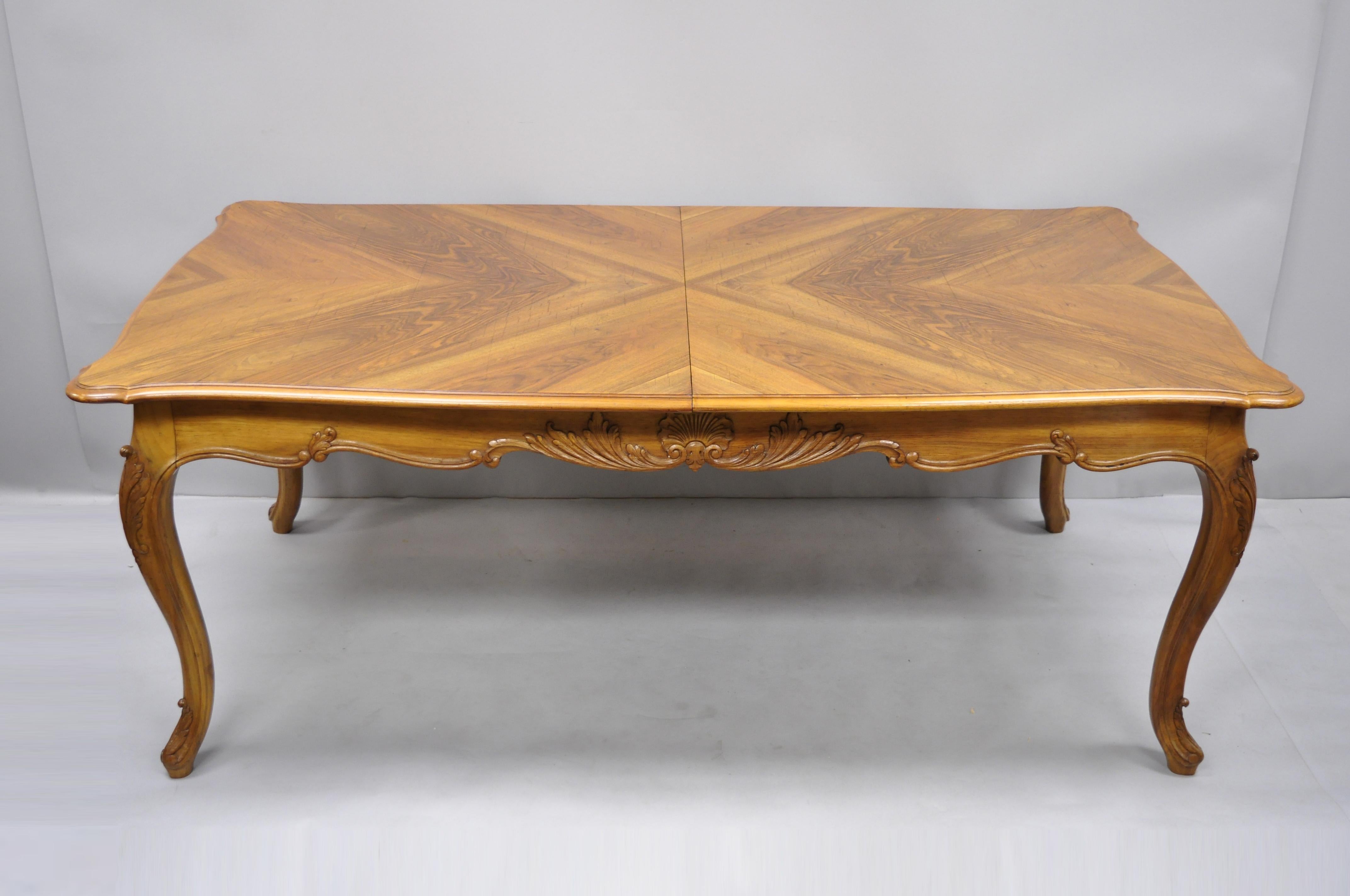 French country Louis XV style shell carved walnut dining table with two leaves. Item features (2) 24