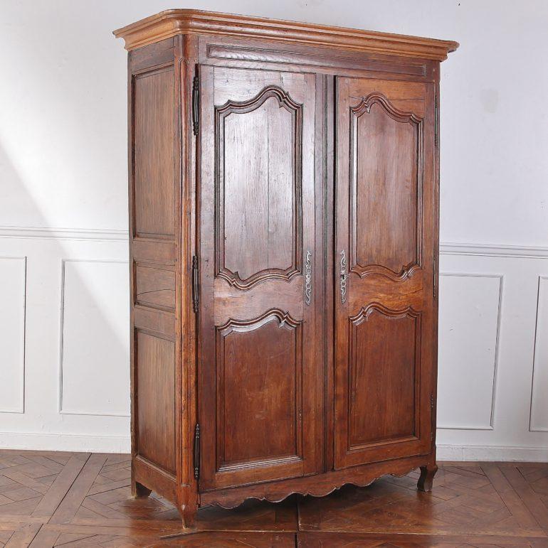 19th century, French country oak armoire with two Louis XV-style shaped-panelled doors, and fitted with adjustable shelves to the interior. May also be fitted with a rod for hanging clothes.