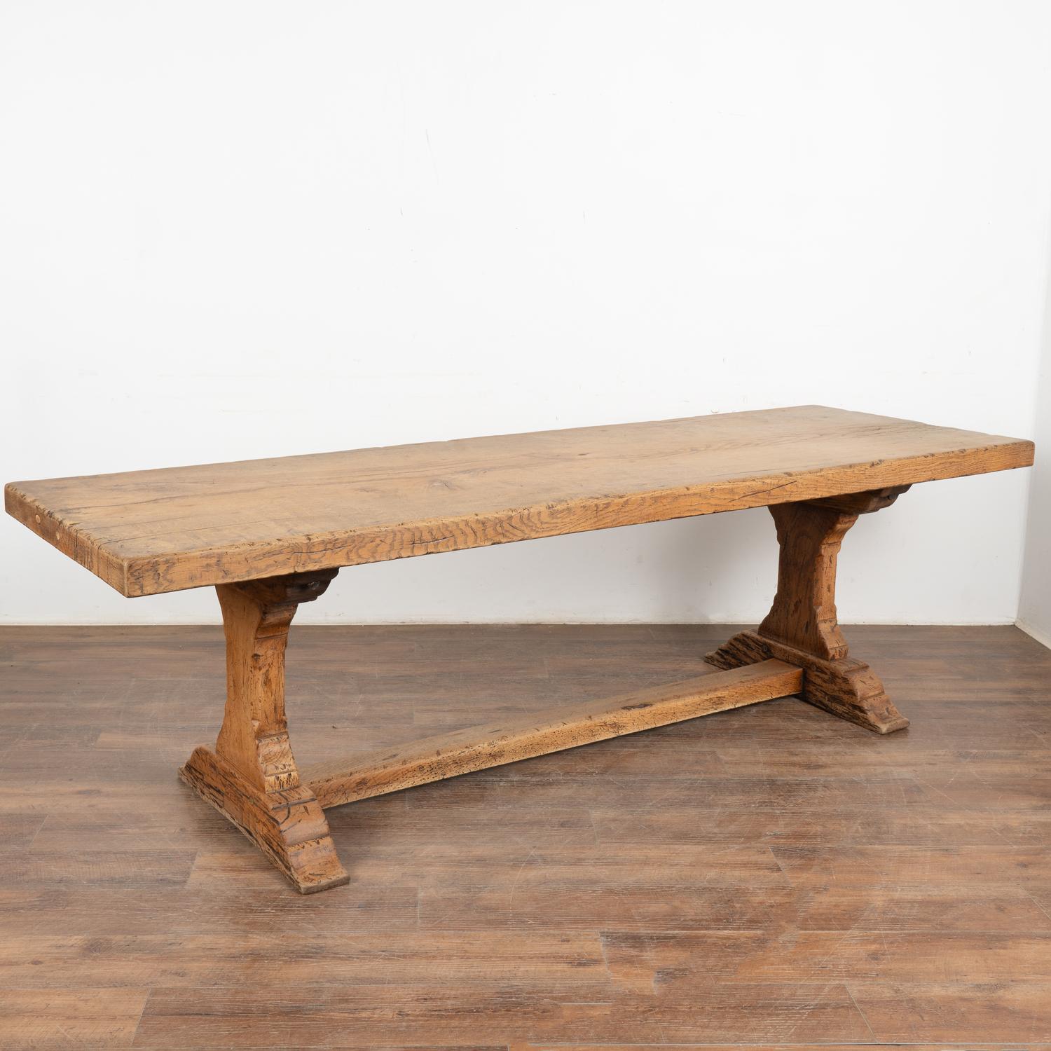 Impressive at just over 8' long with one solid plank top, this dramatic dining table will make a grand gathering place in today's modern home.
The heavy oak top is impressive; rich character is revealed in the scratches, nicks, knots, and distress
