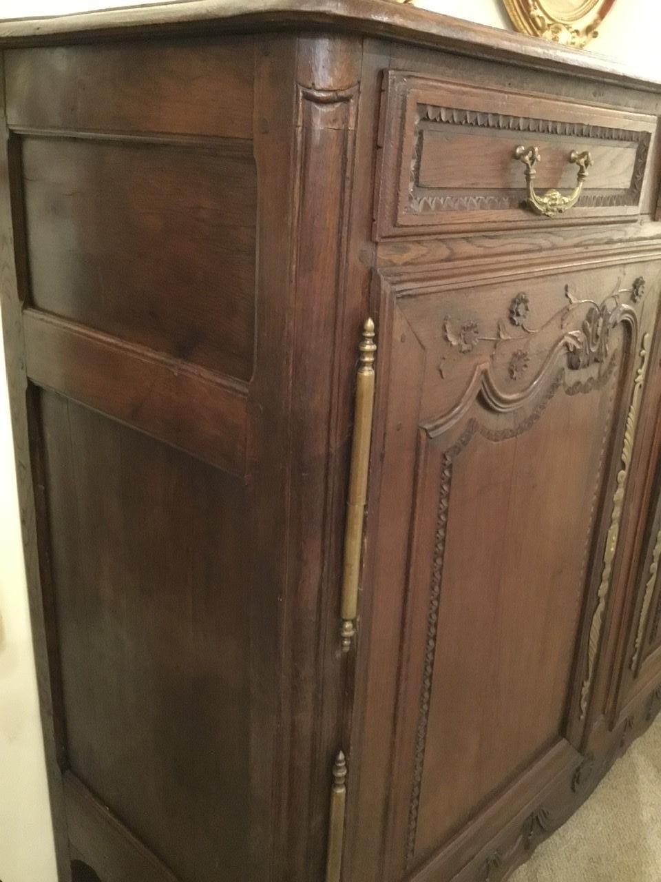 Rustic and handsome oak cabinet with original lock and keys having
Three drawers and two doors that open for great storage. Original
Finish with lovely patina. Hand carving with foliate and floral designs.
Louis XV style leg.