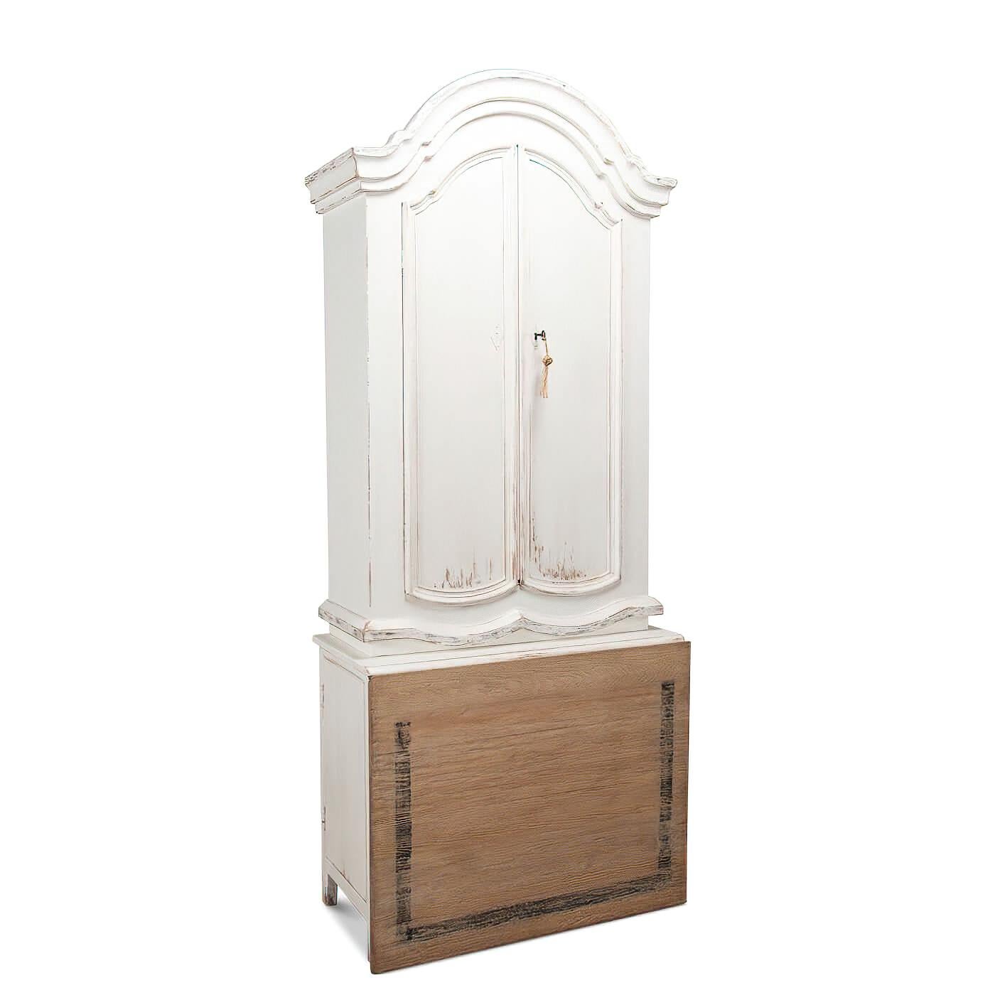 A French Country-style white washed painted secretary bookcase with an unusual folding writing surface that can convert to a table. It features a beautiful molded bonnet at the top. The upper cabinet has adjustable shelves and the sides of the
