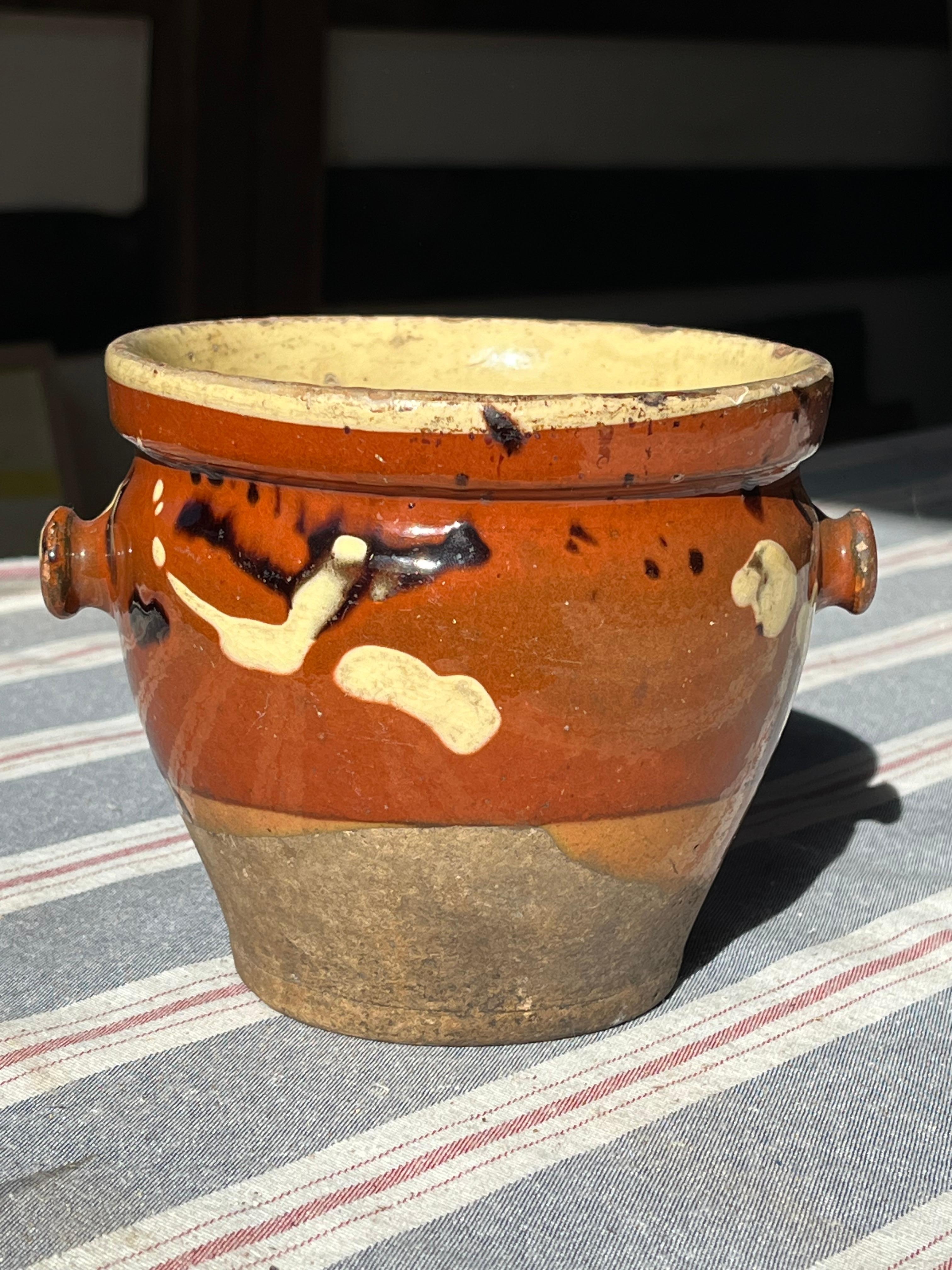 A French faience Jaspe pot with handles, from the Savoie region, brown glaze with yellow and black glaze decoration, circa 1890.