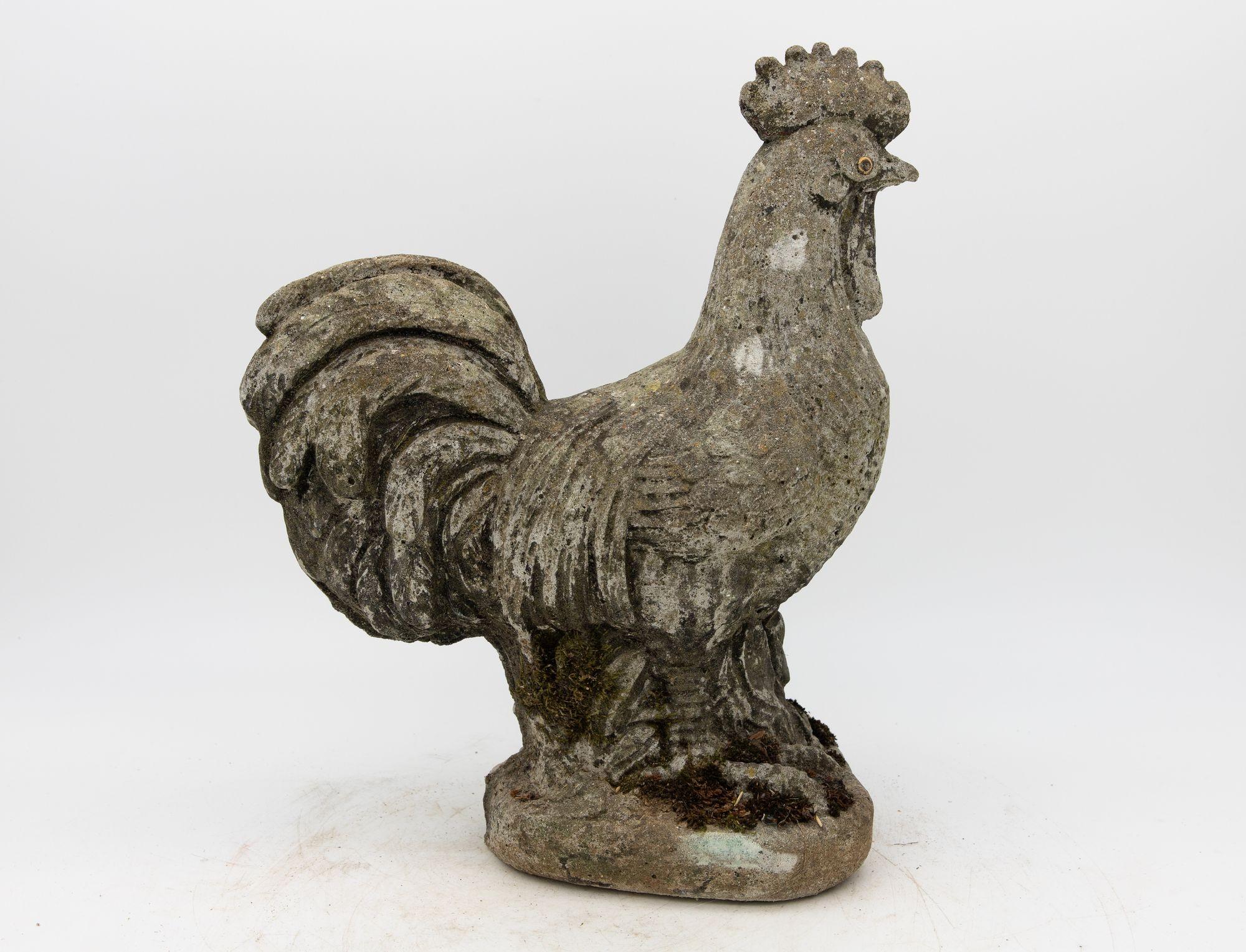 This iconic French Country rooster sculpture, fashioned from aged concrete, exudes rustic elegance and timeless allure. With an honest age and weathered patina, it bears the marks of the passage of time, lending it an authentic and vintage