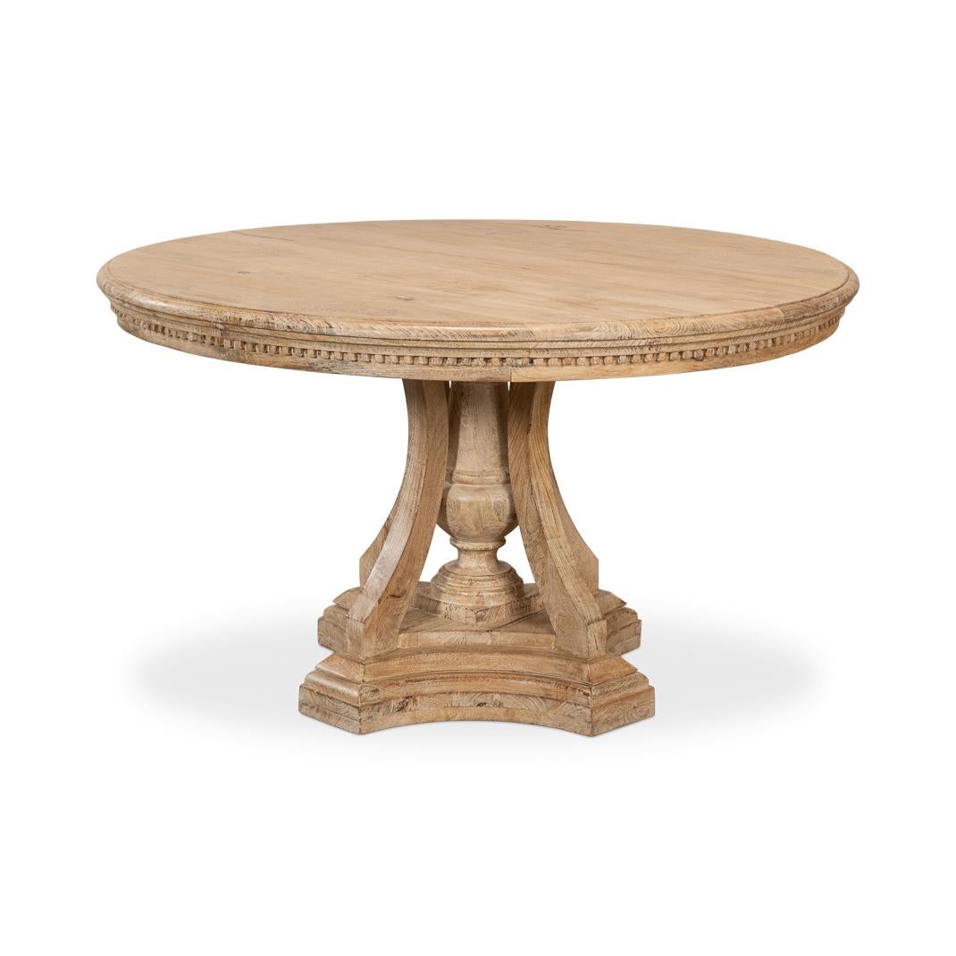 A timeless classic dining table, a piece that exudes rustic charm and invites intimate dining experiences. The table’s beautiful wood surface, with its natural patina, speaks to the stories of shared meals and laughter. The intricately carved dental