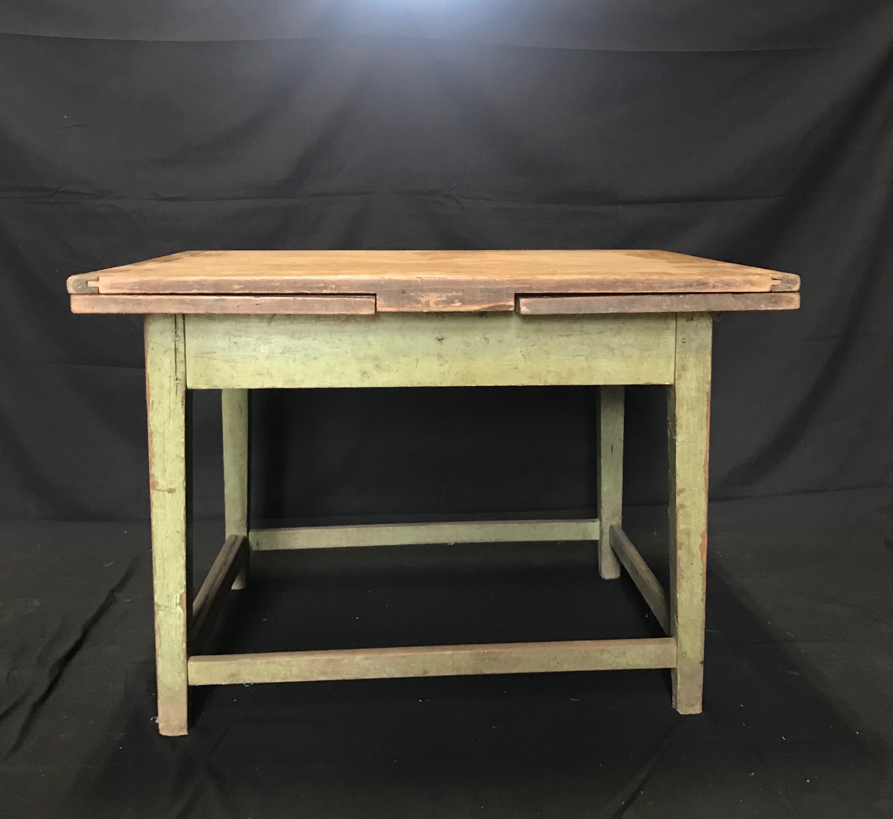 French extendable drop leaf dining table circa 19th century or earlier with original green painted base. Can be three sizes! A very versatile table that takes up very little space, and can be three sizes: the table will extend with both leaves to 6