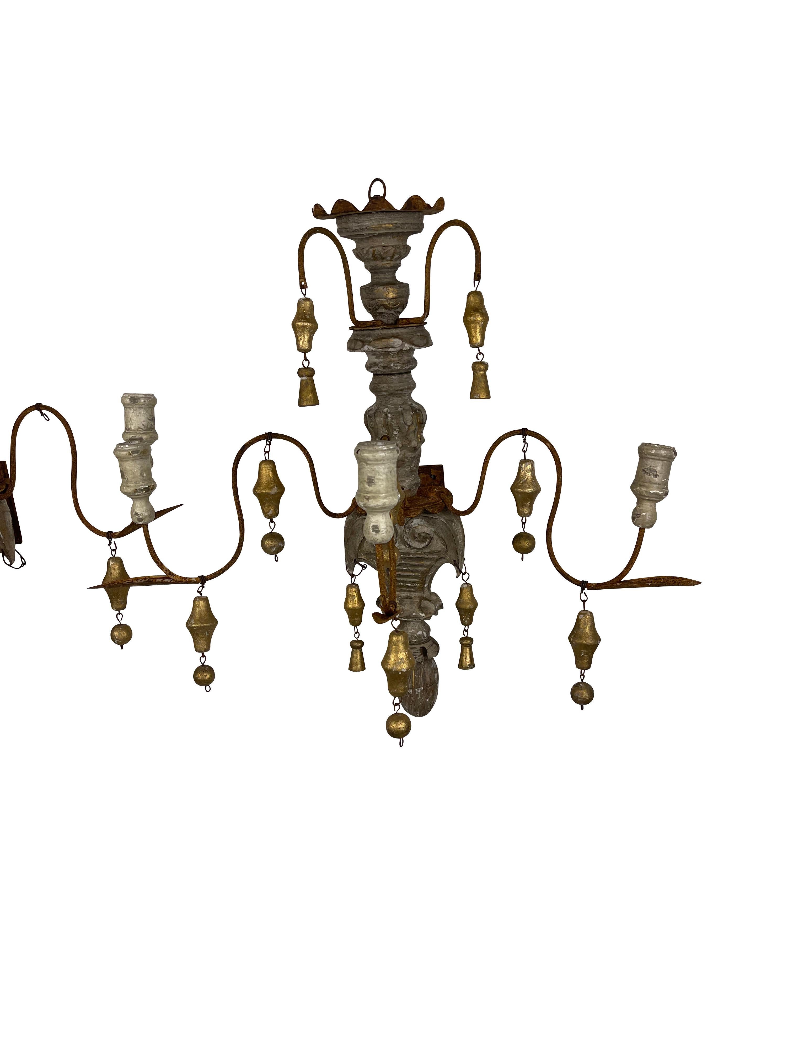 French country chic rustic gilt and grey painted wall sconces. Graceful 4 arm bent wire arms ending in carved candle holders, gilt carved drop pendants add to the country char. Measures 25.5 H X 25 W X 16 D.