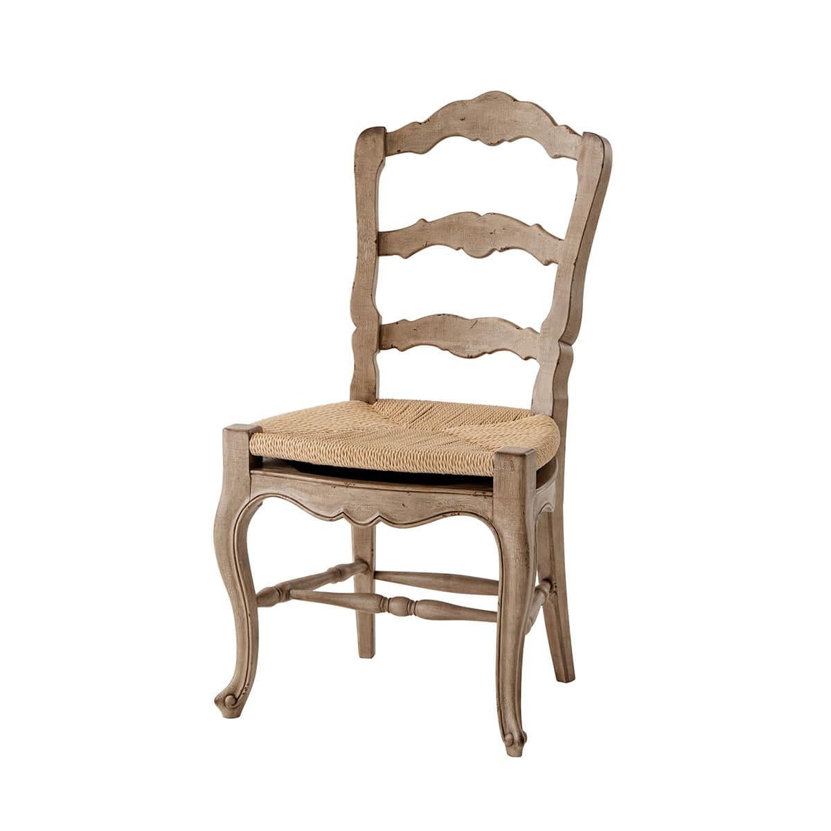Two rustic painted dining chairs, the arched ladder back above a 'floating' faux rush seat, on cabriole legs joined by turned stretchers. Inspired by a 19th-century French original.
Dimensions: 20.75