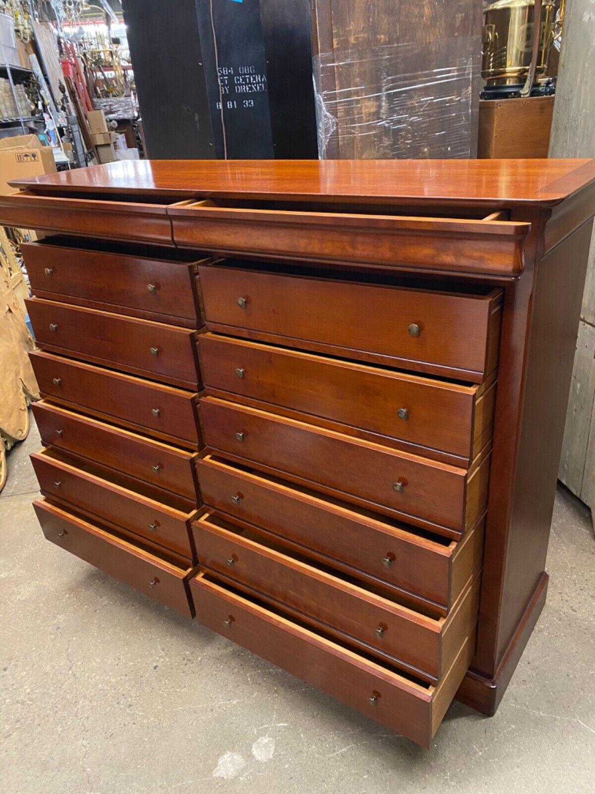 French Country Modern Solid Cherry Wood 14 Drawer Tall Chest Dresser - Made in France, Believed to be by Grange .Item featured is a large impressive size, original label, stamped “Made in France”, 14 dovetailed drawers, clean Modernist lines. Circa