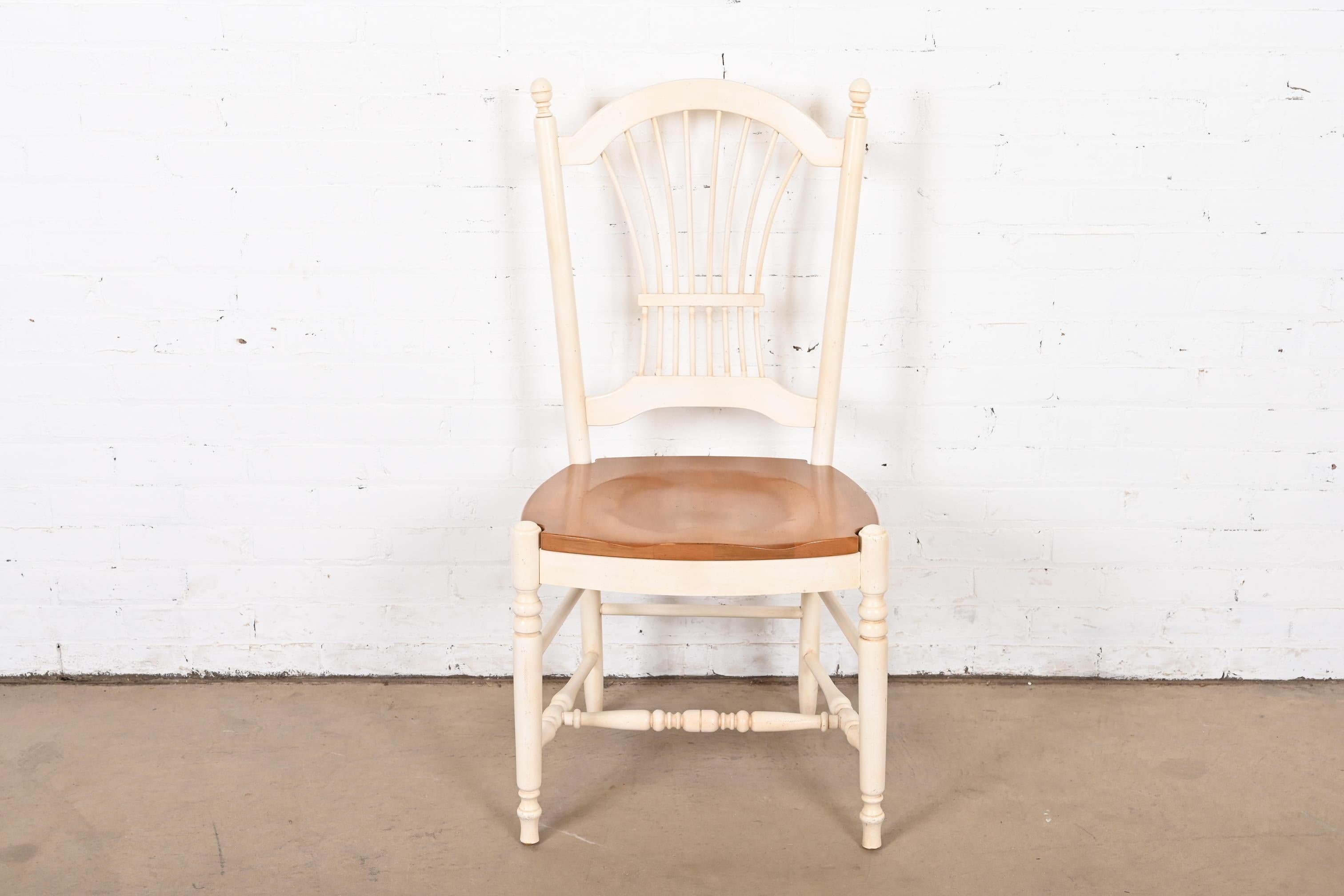 A lovely French Provincial or French Country style desk chair or side chair

USA, Circa 1990s

White lacquered solid maple, with natural maple seat.

Measures: 20