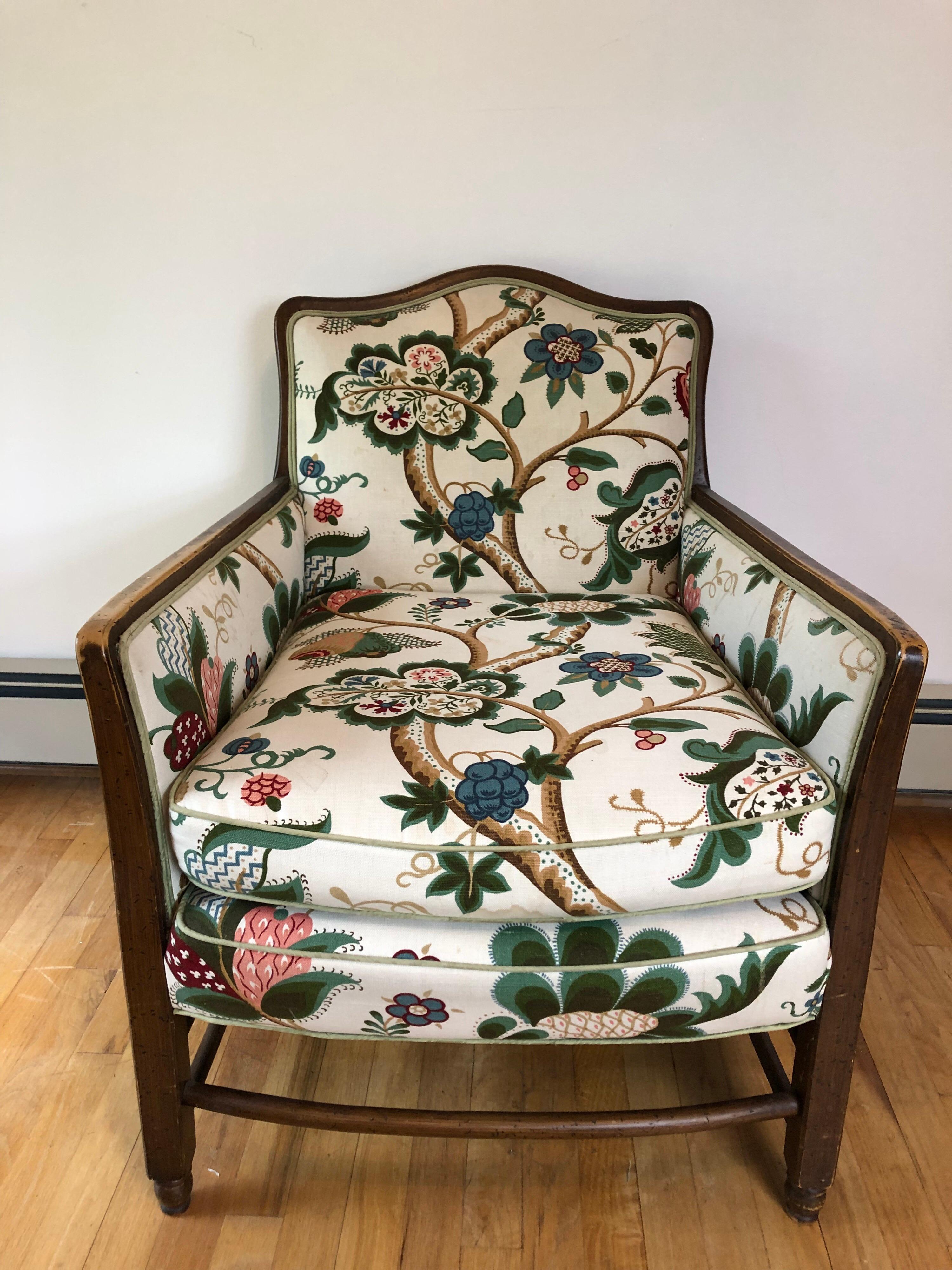 A French country style oak bergere chair. Stretcher base and ladder back. Floral printed cotton canvas upholstery is in excellent condition.