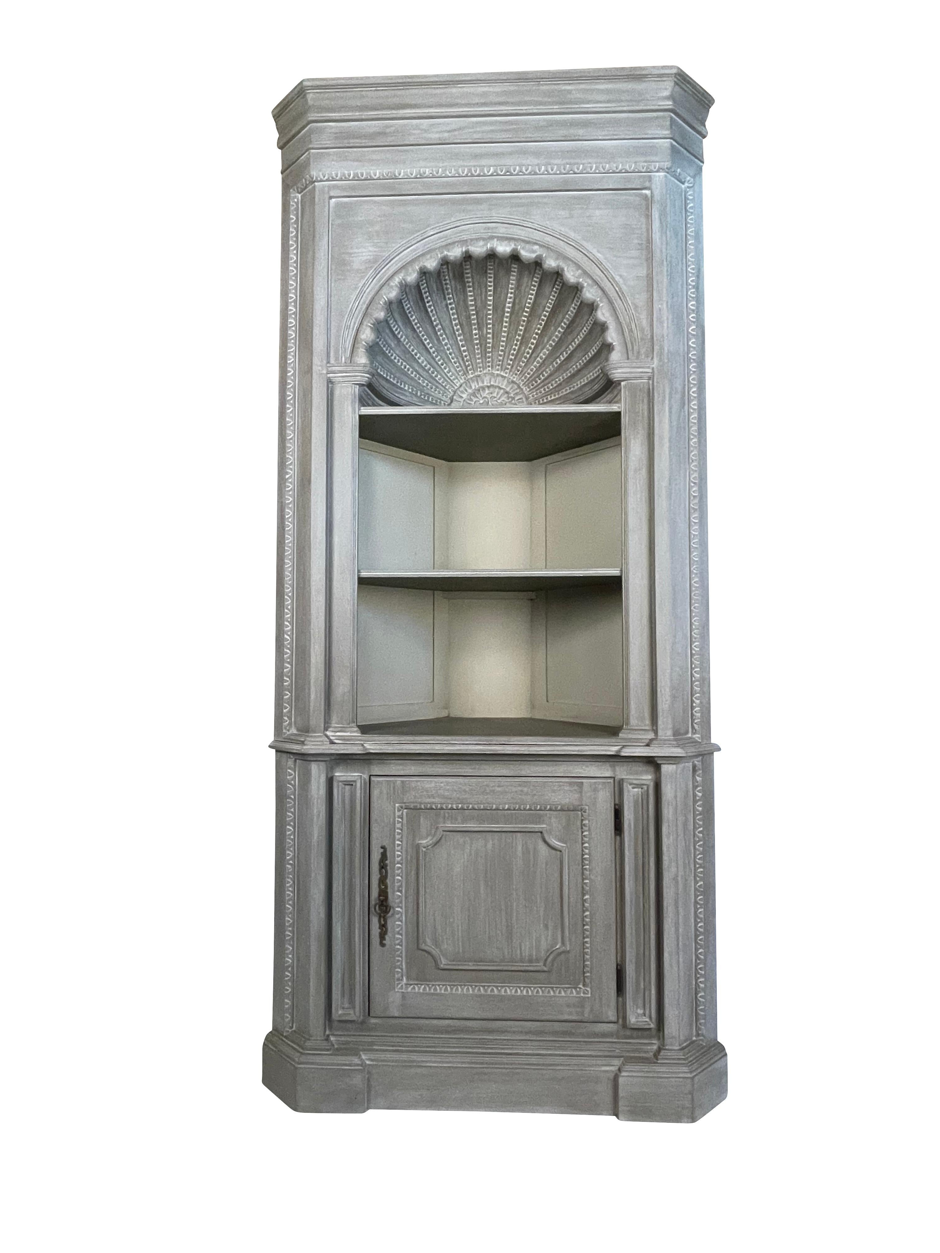 Shell carved grey painted Country French style corner cabinet cupboard
Country French style two-part corner cabinet with central shell accent. This impressive china cabinet/cupboard features an antiqued light grey painted finish, deep-set shell