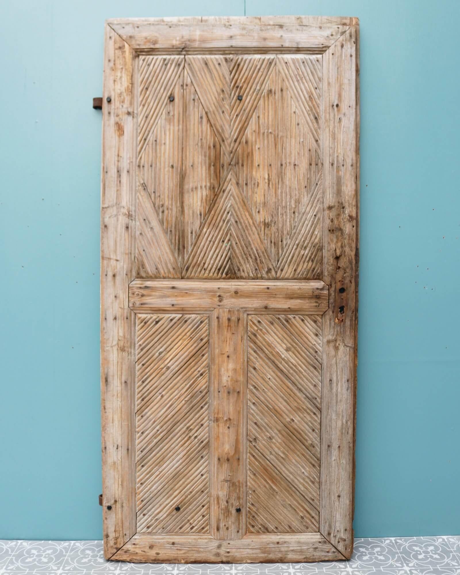 An unusual reclaimed exterior door originating from France, circa 1800. This beautiful antique exterior door makes a handsome entrance or side door to a country style cottage or rustic farmhouse. The door features three panels with an attractive