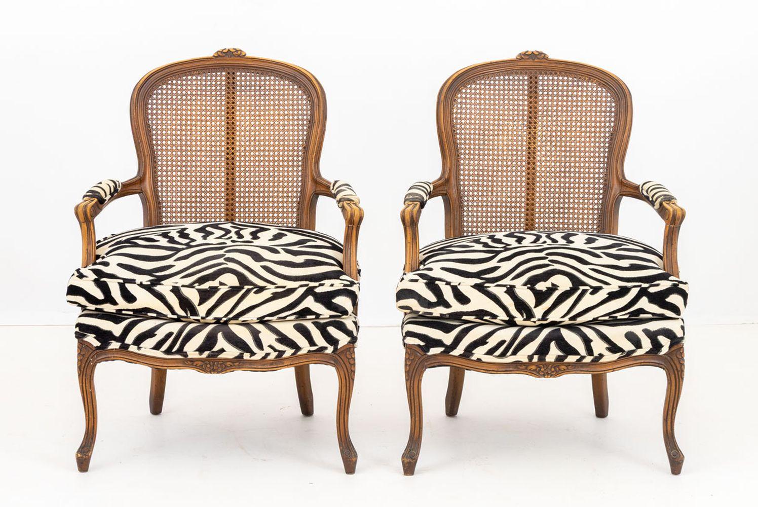 Paire de fauteuils tapissés de zèbre de style provincial français, cadre en noyer avec crête florale au-dessus d'un dossier canné et tapissé de zèbre noir et blanc sur quatre pieds cabriole. 37