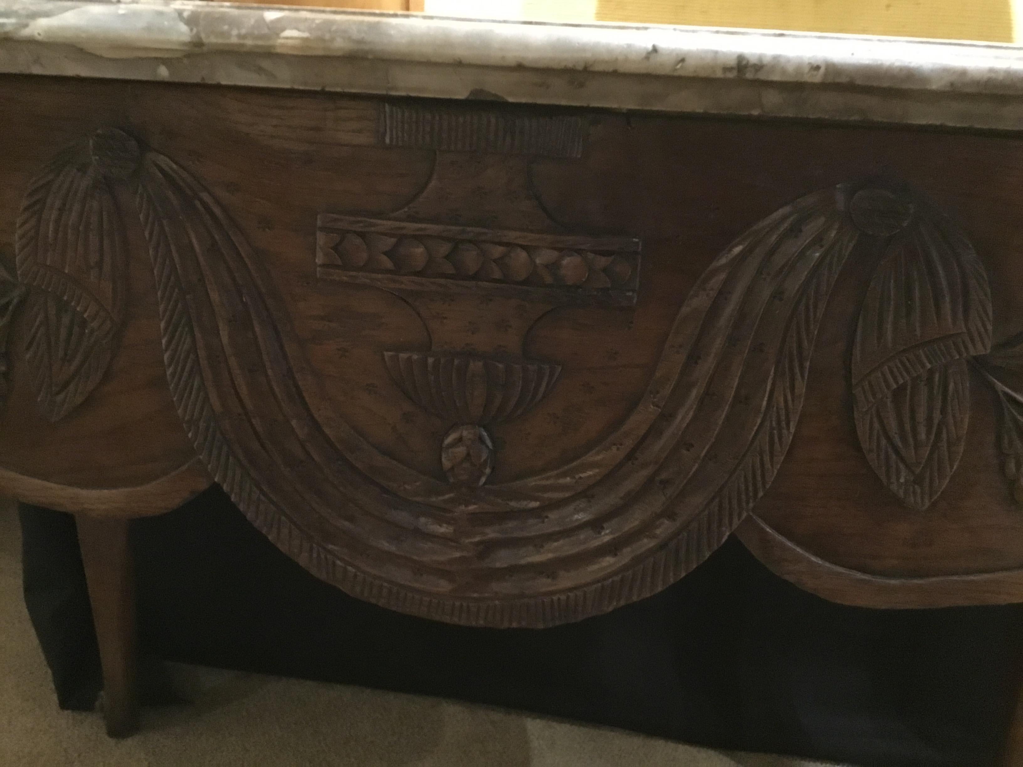 French country Louis XVI style table with lovely carved apron with carved central design on
The front of the apron. Floral and foliate design graces the design work. Marble top in taupe
And cream colors. Bull nosed edge. This table is structurally