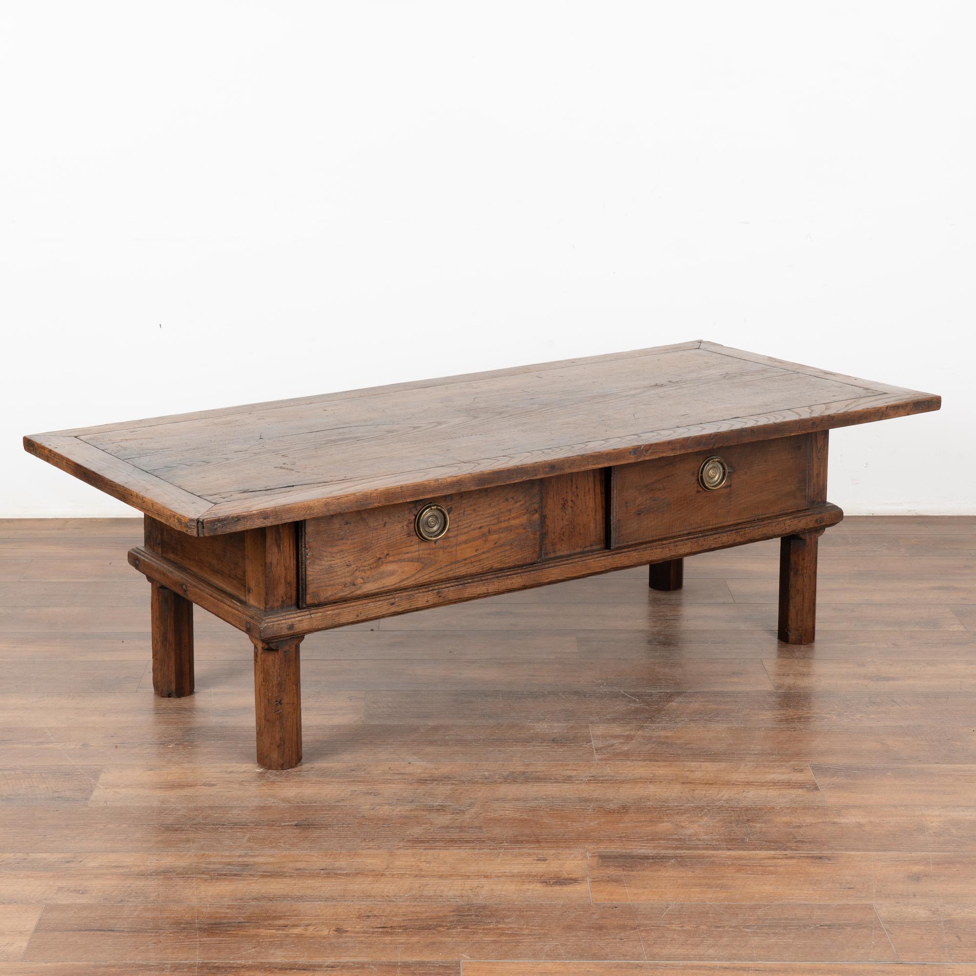 The rustic appeal of this oak coffee table comes from the aged patina of the worn wood.
Every scratch, nick, crack , gouge and stain simply add to the strong draw of this French country coffee table with two drawers.
Restored, solid, stable and