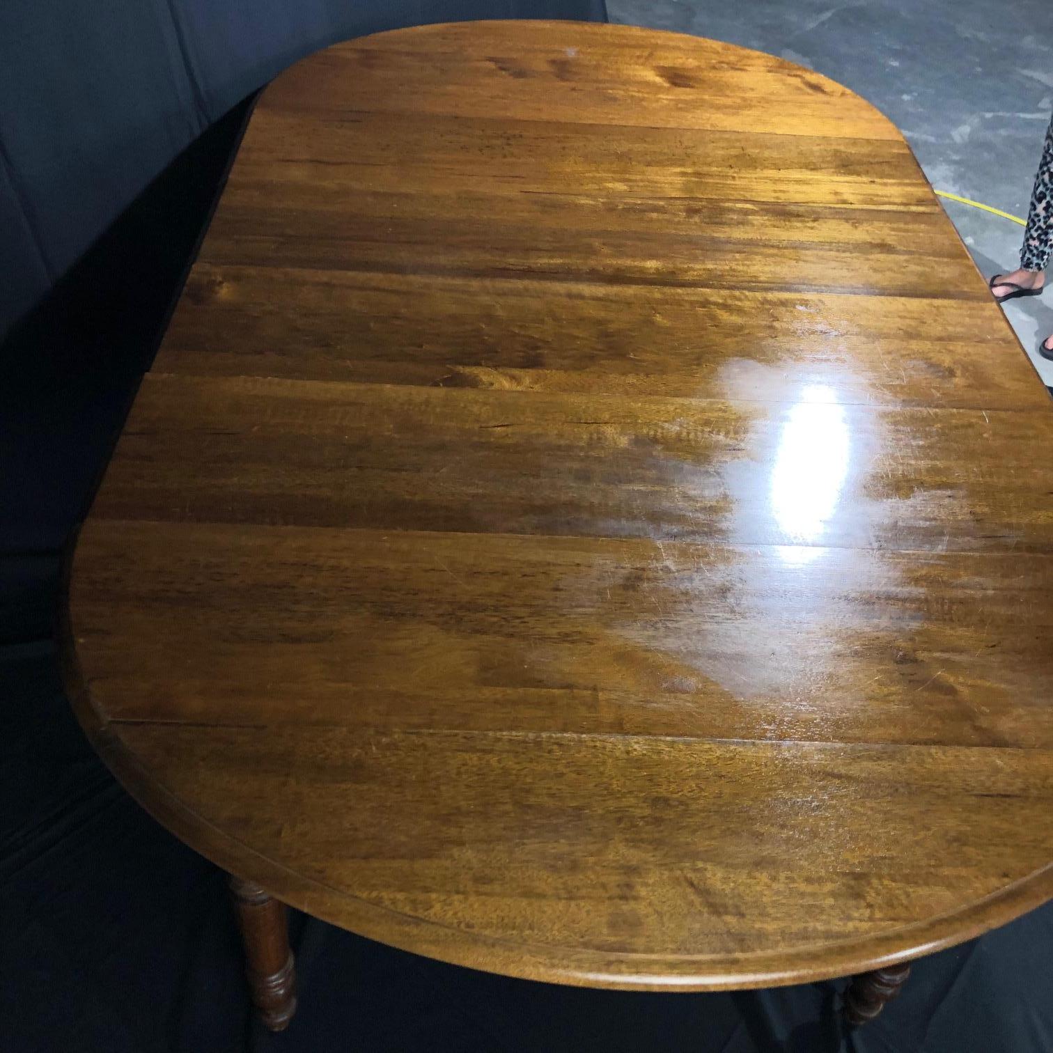 Fabulous, rare, large 19th century French country walnut dining table with four leaves and exquisitely turned legs, straight from Normandy. The table is very versatile – from 24” as a drop-leaf table with sides down, to over 7 ½ feet oblong with