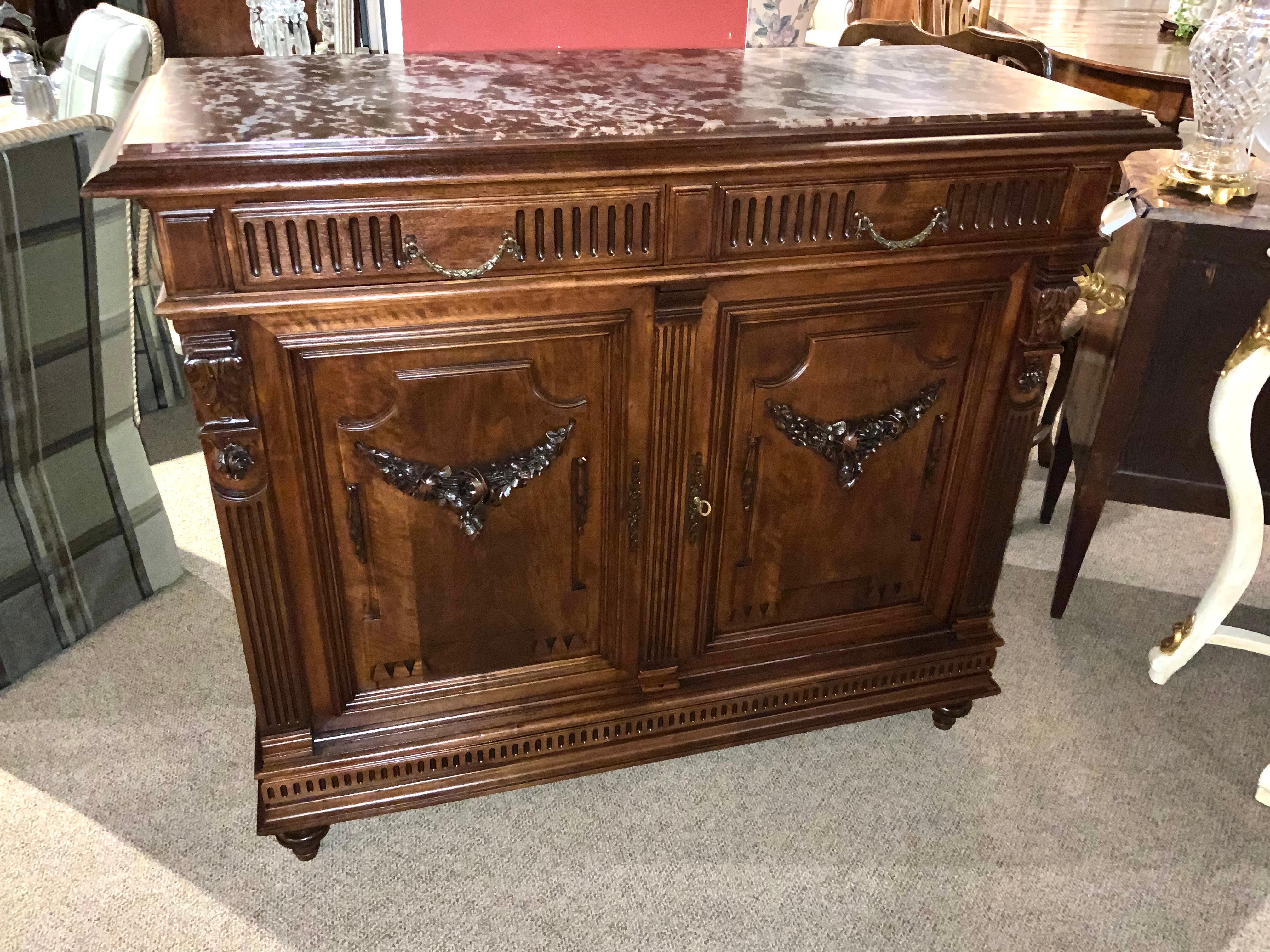Louis XV-style in a beautiful dark walnut wood makes this piece 
Exceptional! It is very desirable from the standpoint of being both handsome
And useful with great storage. It has a rouge marble top without restorations 
Which makes it great for