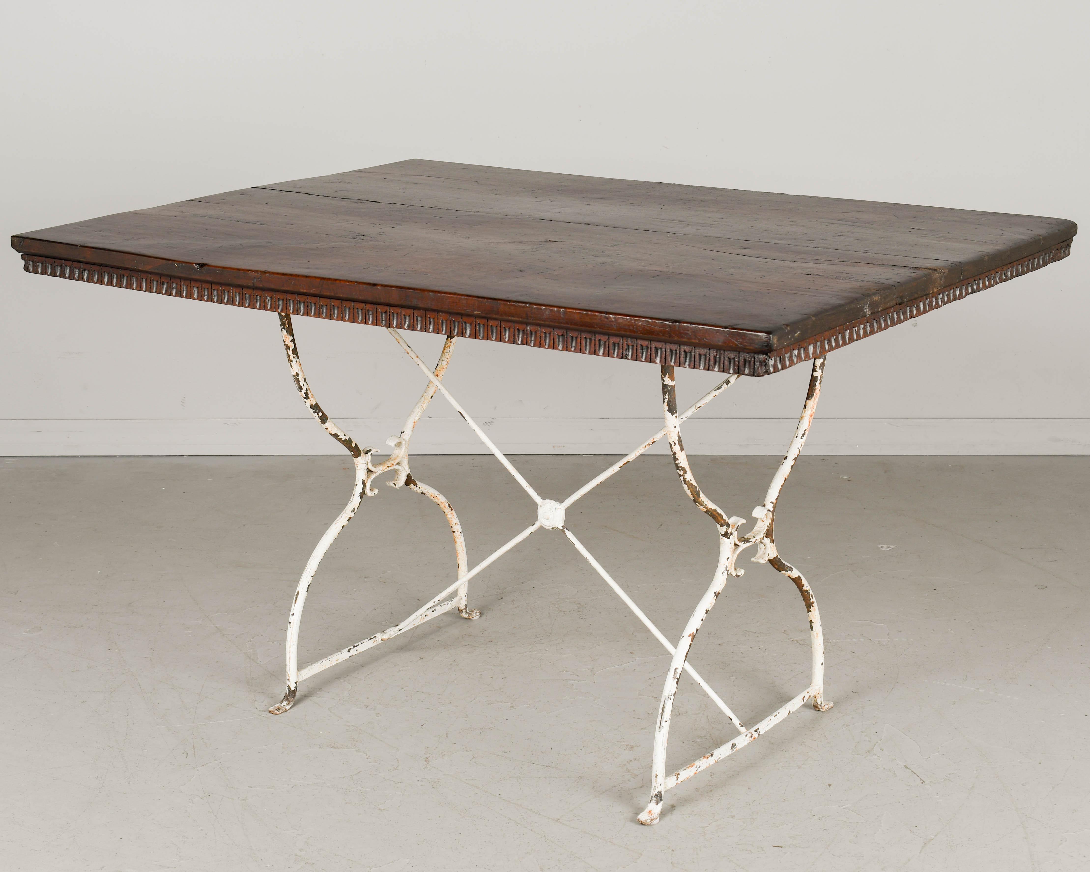 Hand-Carved French Country Walnut Table with Iron Base For Sale