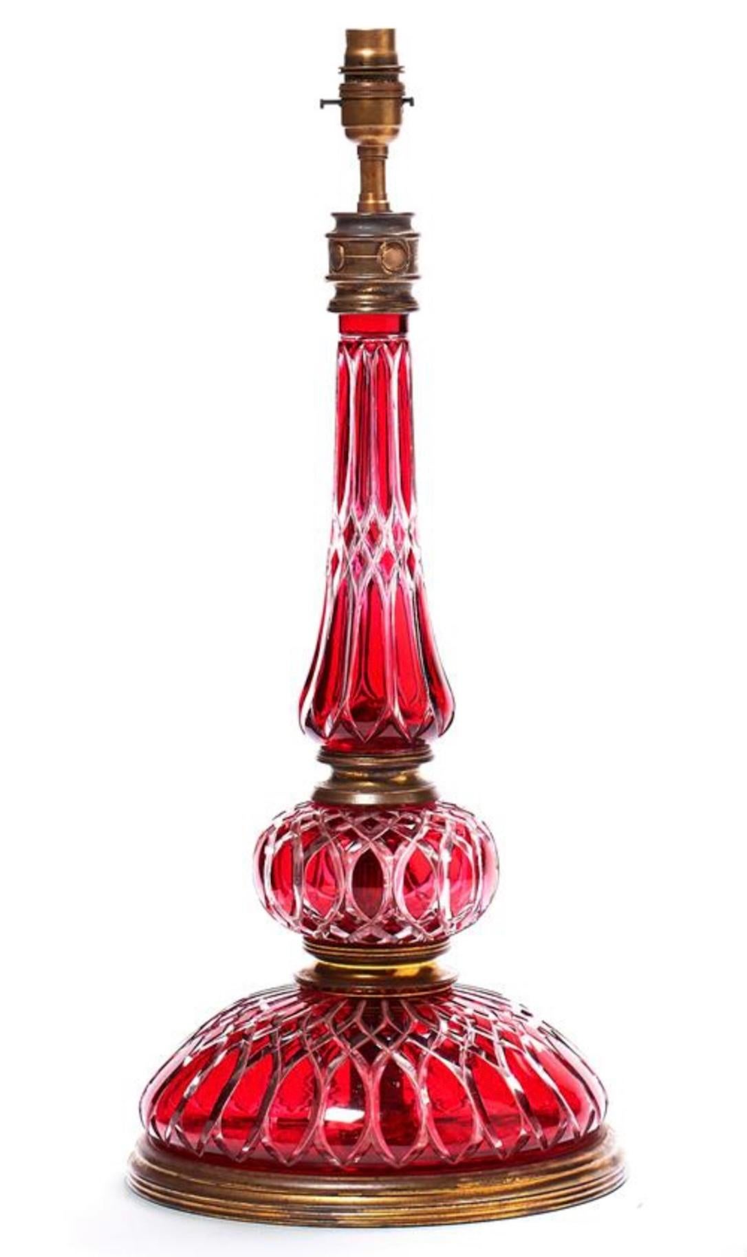 A superb pair of French 19th century cut cranberry glass lamps with gilt metal detailing and plinth bases.

Height of lamps: 21 1/4 in (54 cm) including electical fitment and the bases, excluding lampshades.

All of our lamps can be wired for use