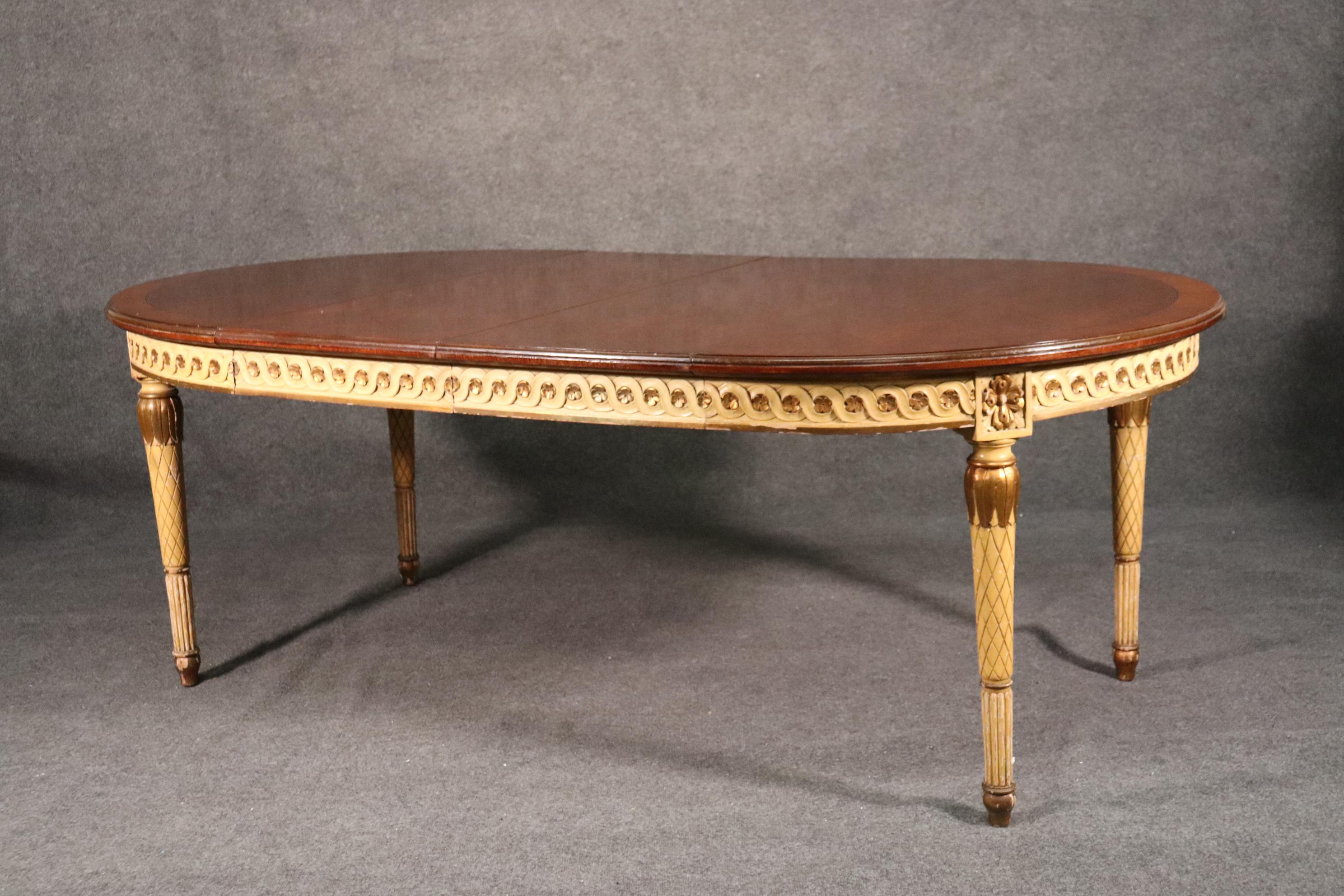 This gorgeous dining table has some beautiful characteristics and a delightful presentation. The top is parquet walnut and the carved frame of the table is in a crème painted finish with gold leaf gilding. The table is 48 x 48 x 30 inches tall and