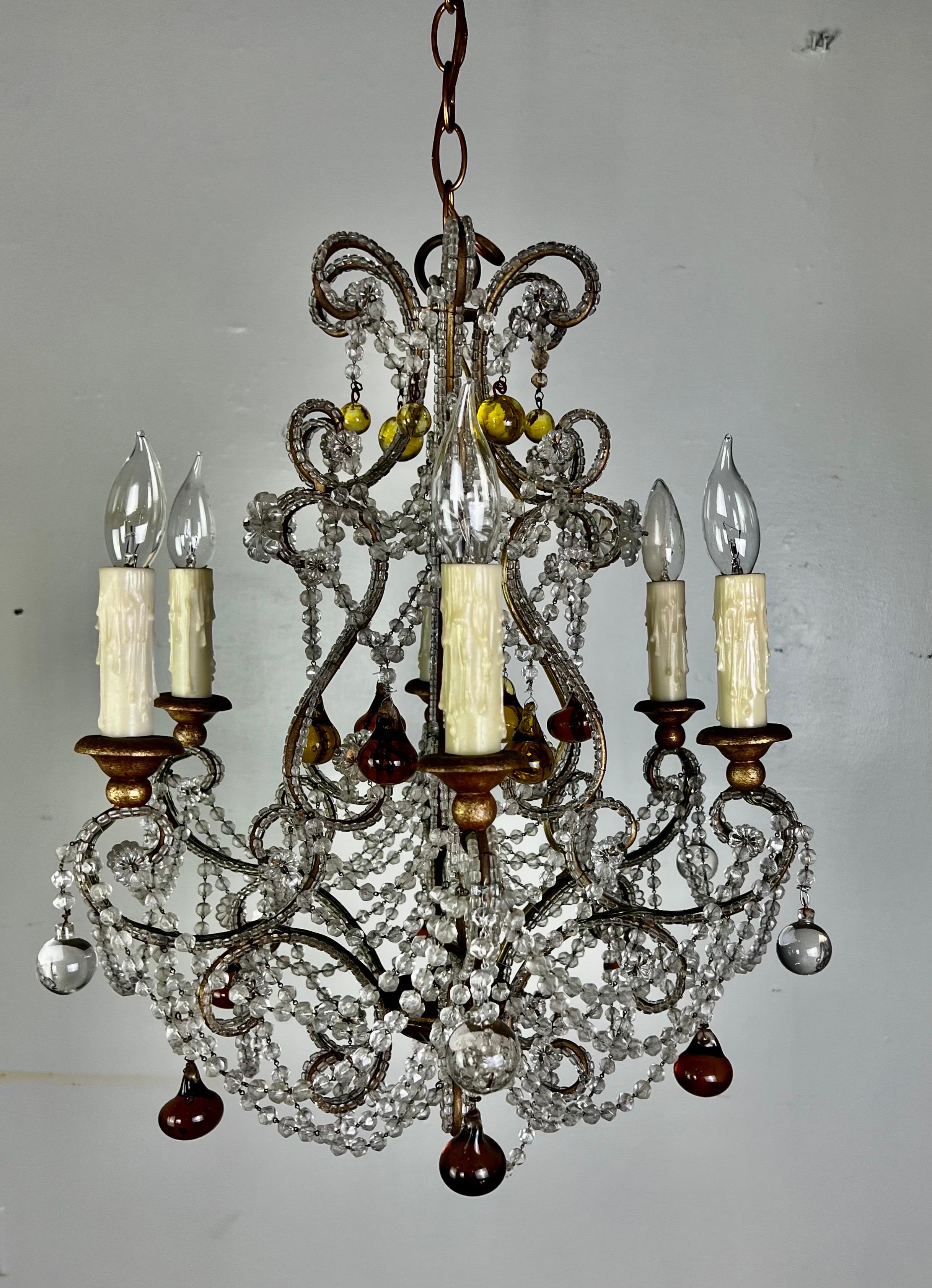 French six light crystal chandelier adorned with garlands of crystal beads, crystals, and amber/topaz hand blown glass drops. The fixture is newly rewired with drip wax candle covers. Chain & canopy included.