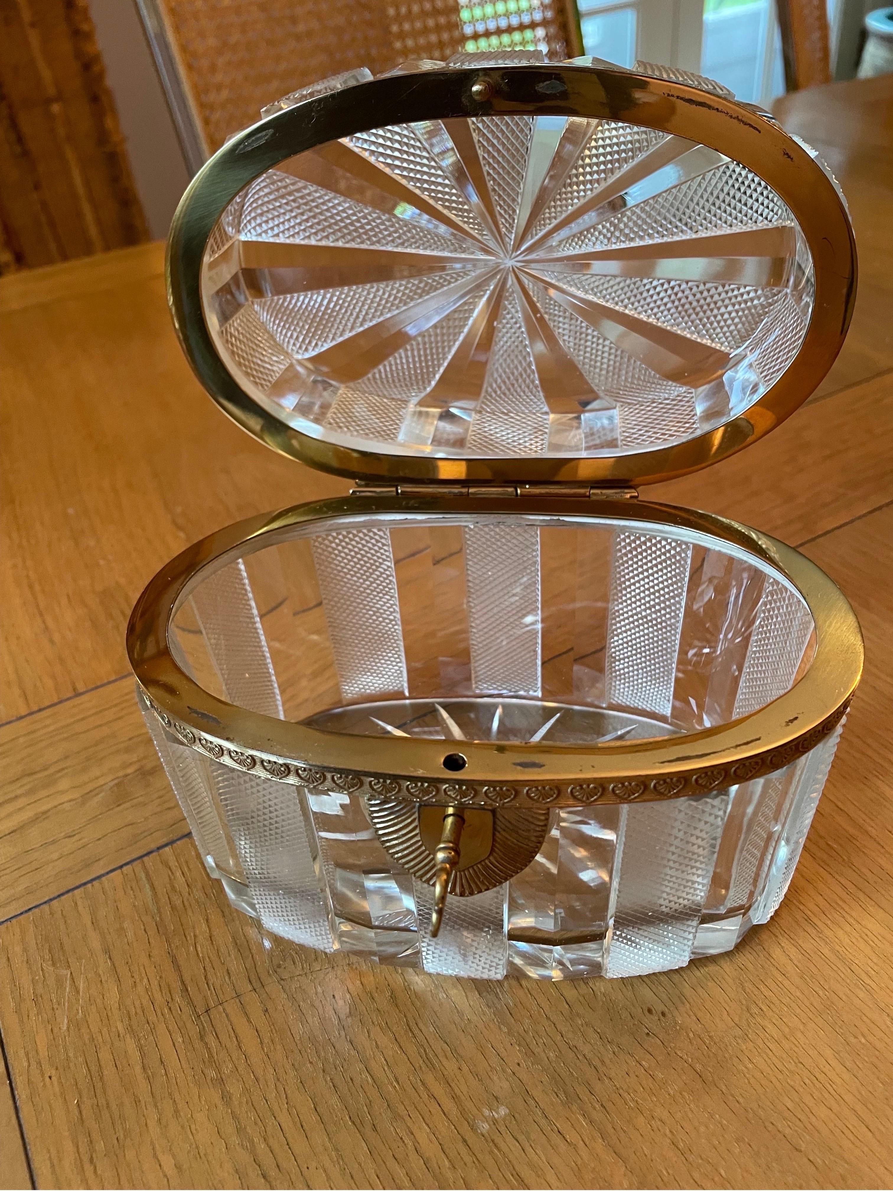 This is a lovely oval French crystal casket box with brass ormolou and locking key 