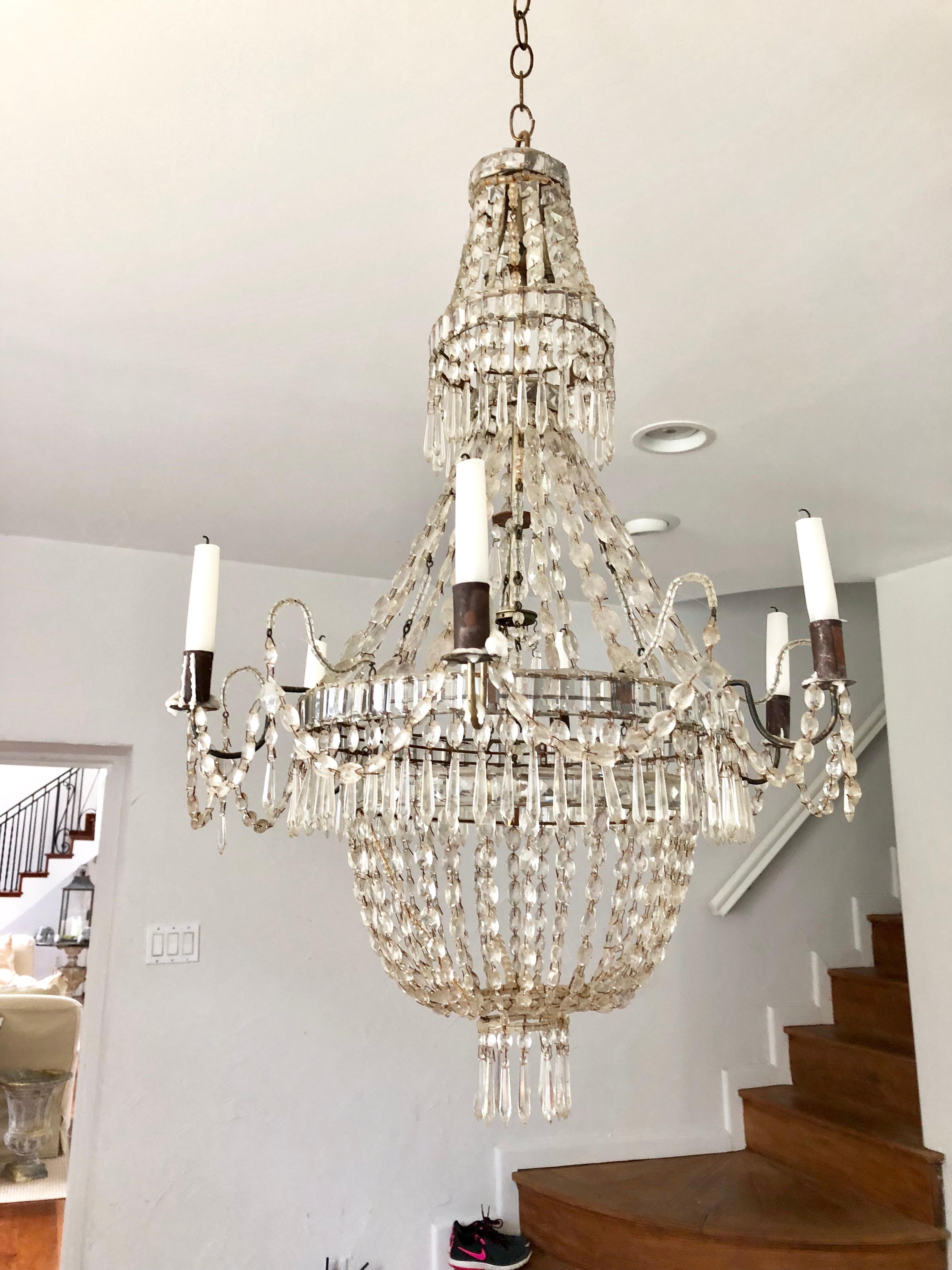 A charming French Provincial hand-cut, graduated crystal chandelier with 6 tile arms and candle cups in the Louis XVI manner,.