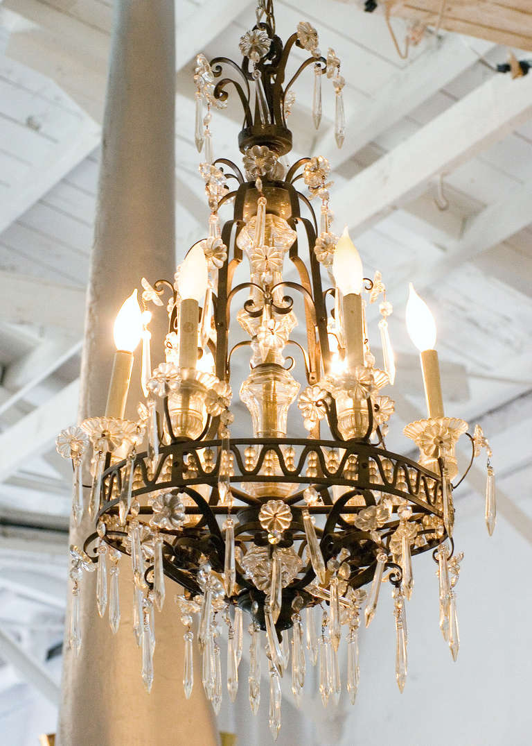 Awash in crystals, this exceptional French crystal and bronze chandelier in excellent condition with eight lights. The frame and crystals having been taken apart, restored re-wired and re-assembled and is ready to hang.