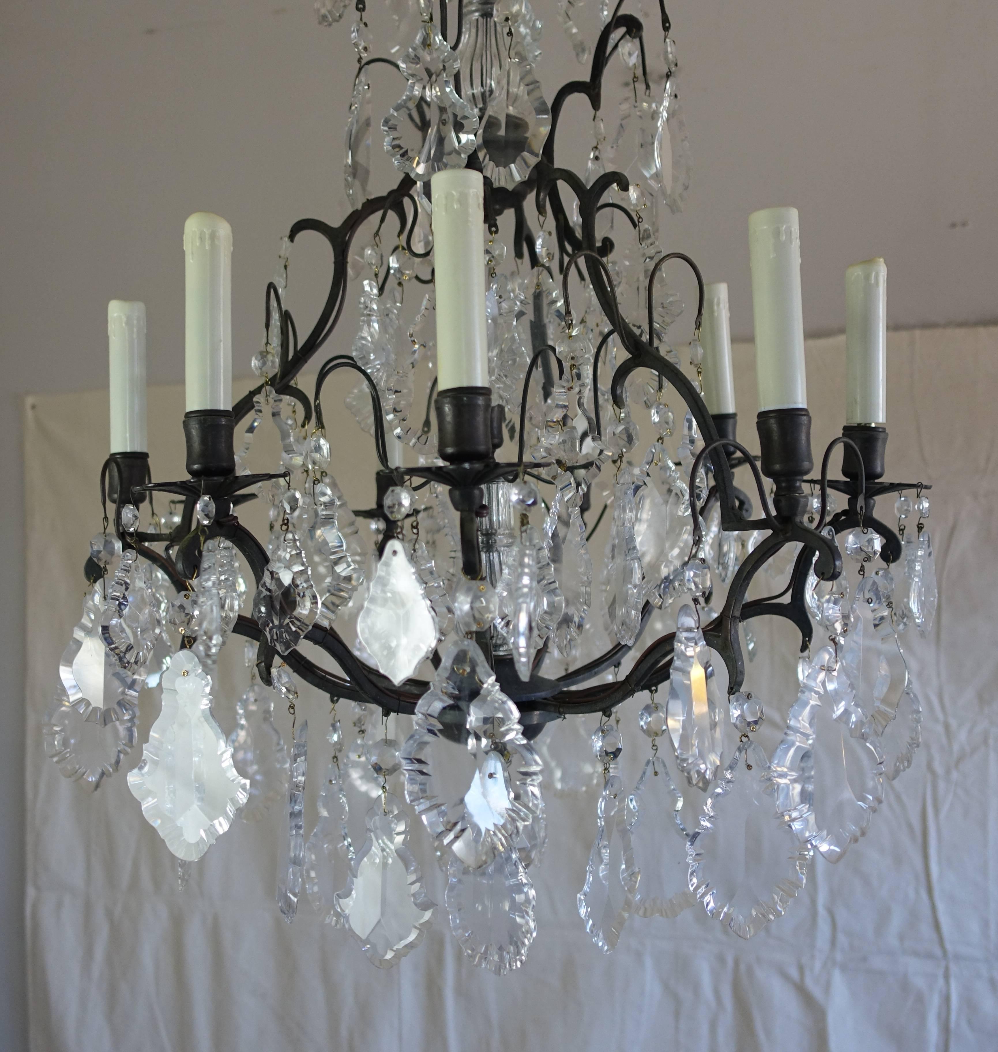 French crystal (nine) light chandelier with an antique finished brass frame adorned with quality pendeloque shaped crystals throughout. Great scale for a bedroom, dining room or entry. The fixture is wired with American sockets and is ready to