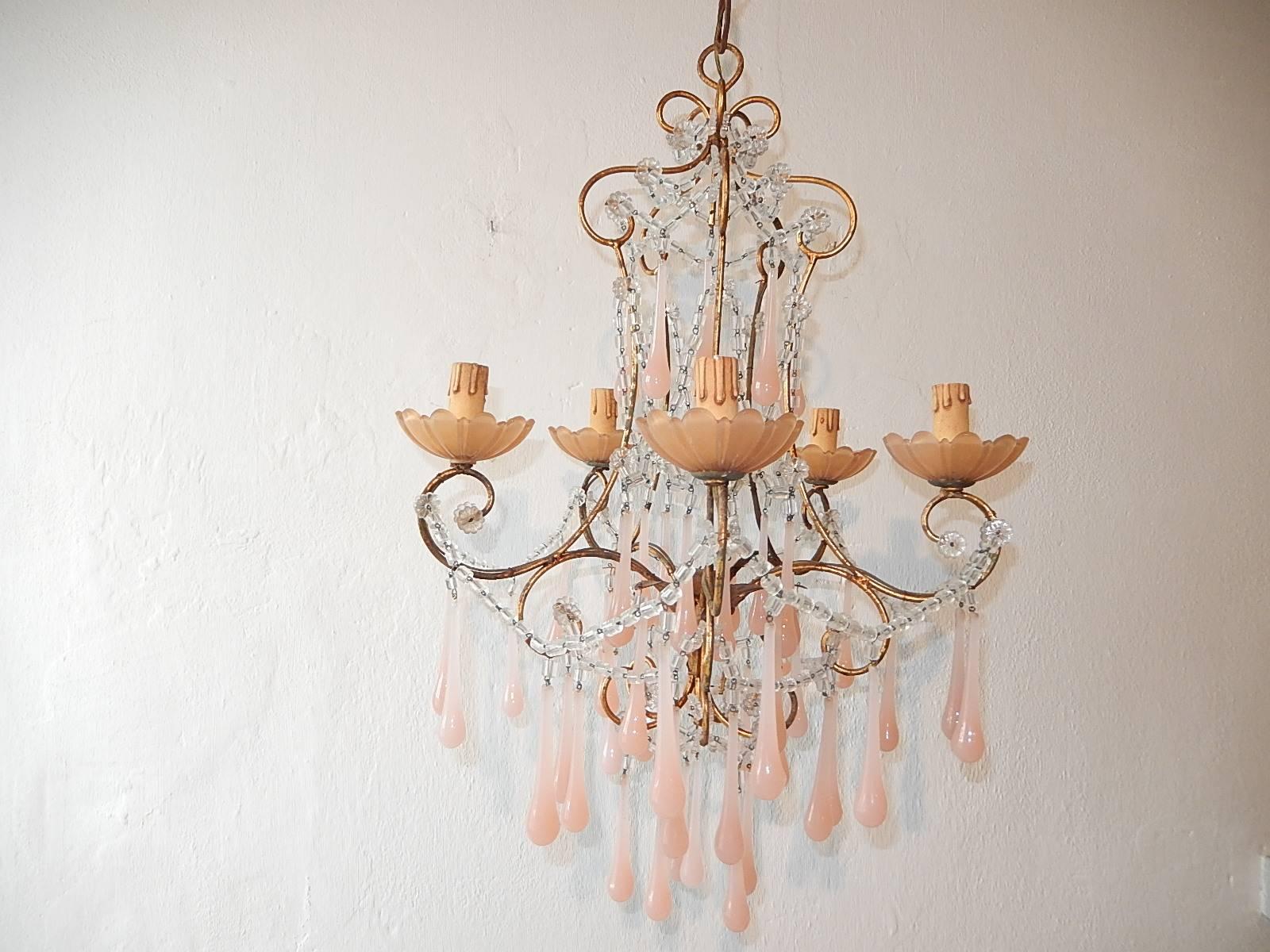 Housing five-light sitting in pink opaline bobeches. Will be rewired with appropriate sockets for country and ready to hang. Metal body with swags of macaroni beads. Bubble gum pink opaline drops. Opaline bobeches as well. Adding another 22