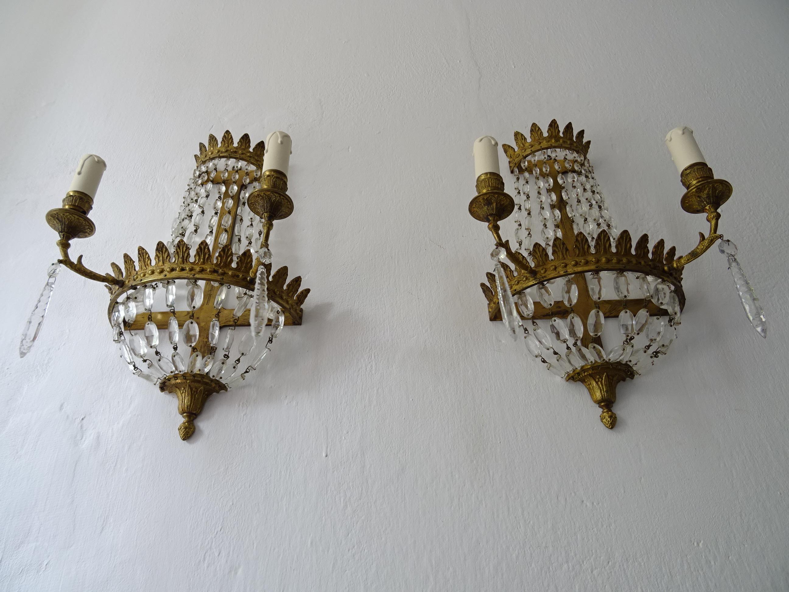 Housing two lights each, will be newly rewired with certified UL US socket for the USA and certified socket for other countries and ready to hang. Bronze with great detail and patina.. Adorning rare oval crystal prisms throughout, all intact. Free