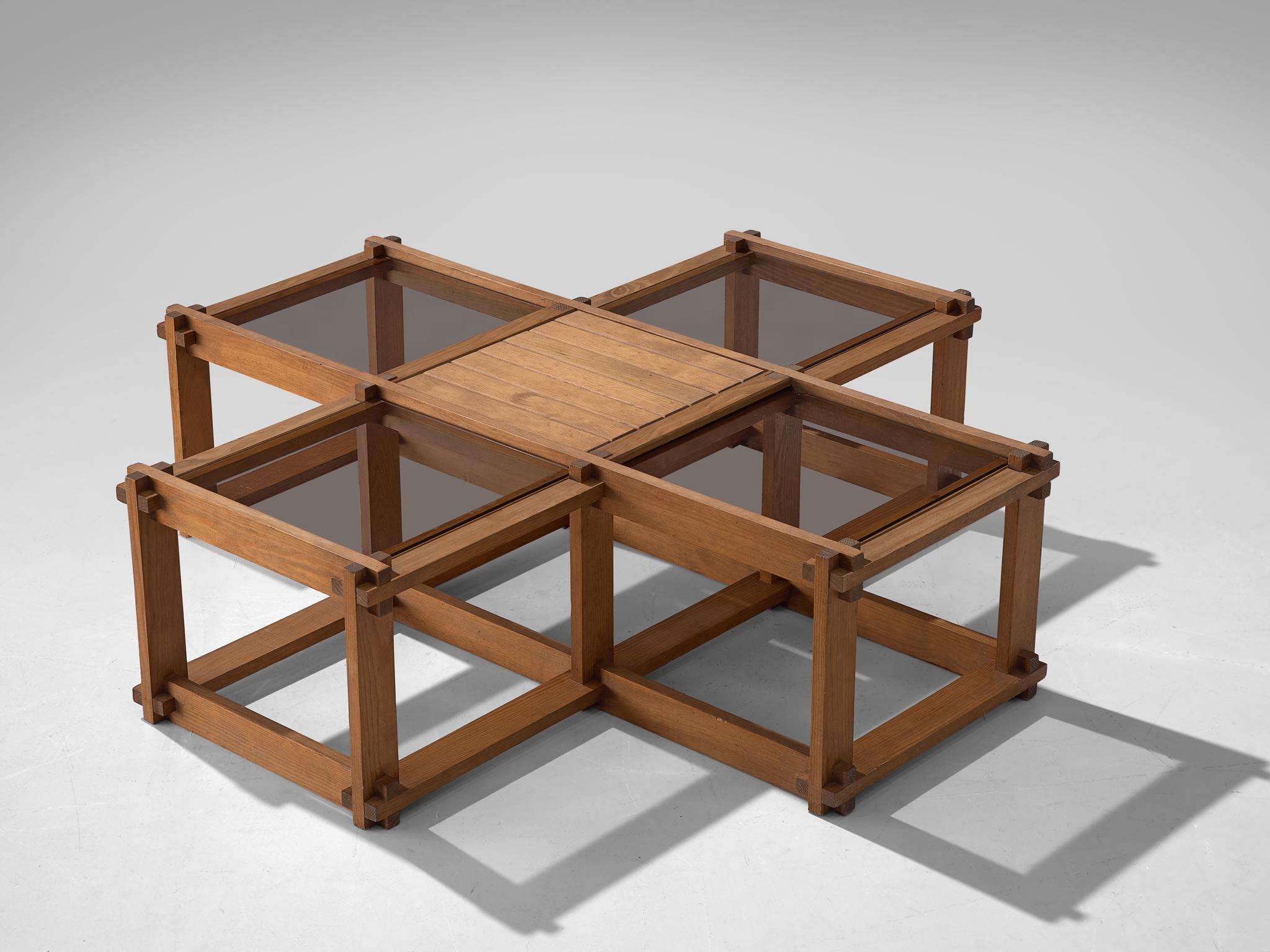 Coffee table, elm and glass, France, 1960s

Constructivist coffee table in elm, build up in a elm grid that composes five concatenated cubes. Only the tops of the cubes are closed, four with glass and one with elm. The sides are open, which keeps