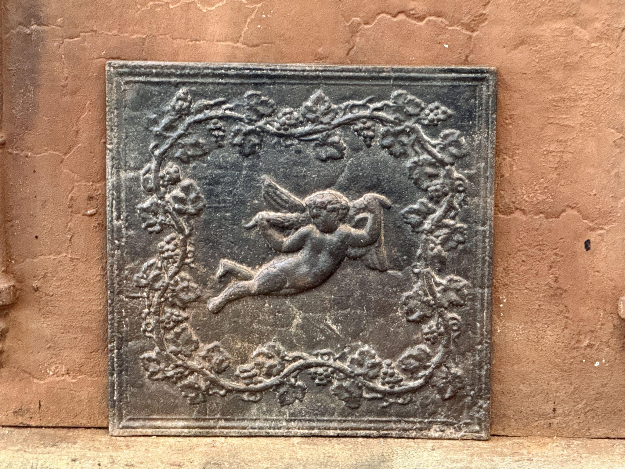 19th century French Napoleon III Period fireback with a cupid.

The fireback is made of cast iron and has a natural greyish patina. Upon request, it can be made black/pewter at no extra cost. It is in good condition and does not have cracks.