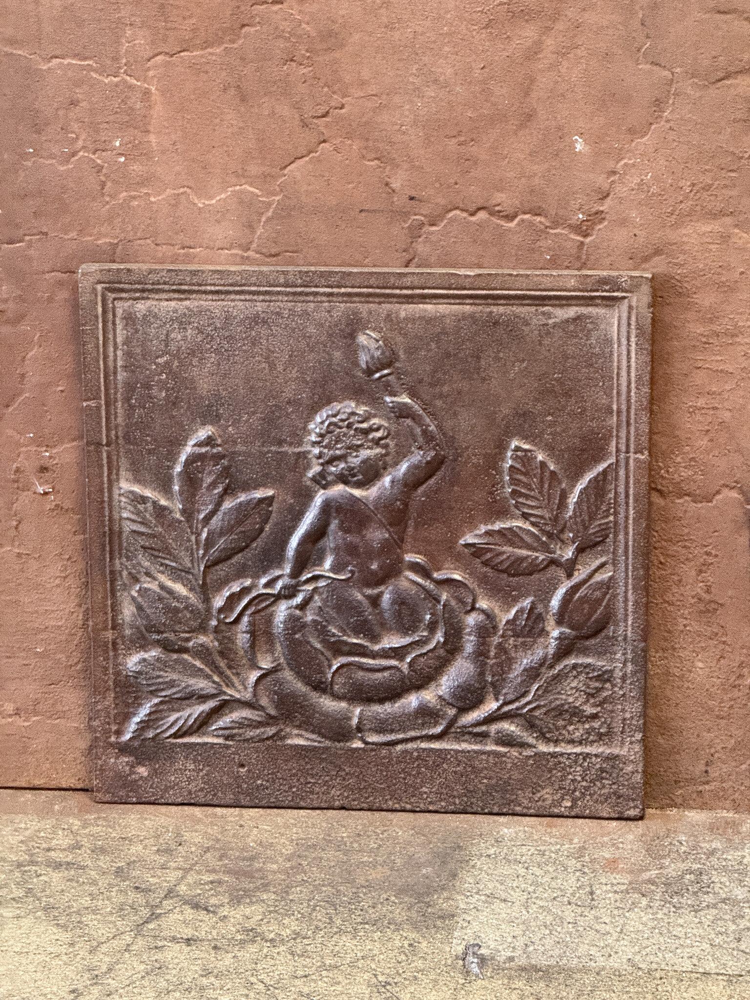 19th century French Napoleon III Period fireback with a cupid.

The fireback is made of cast iron and has a natural brown patina. Upon request, it can be made black/pewter at no extra cost. It is in good condition and does not have cracks.