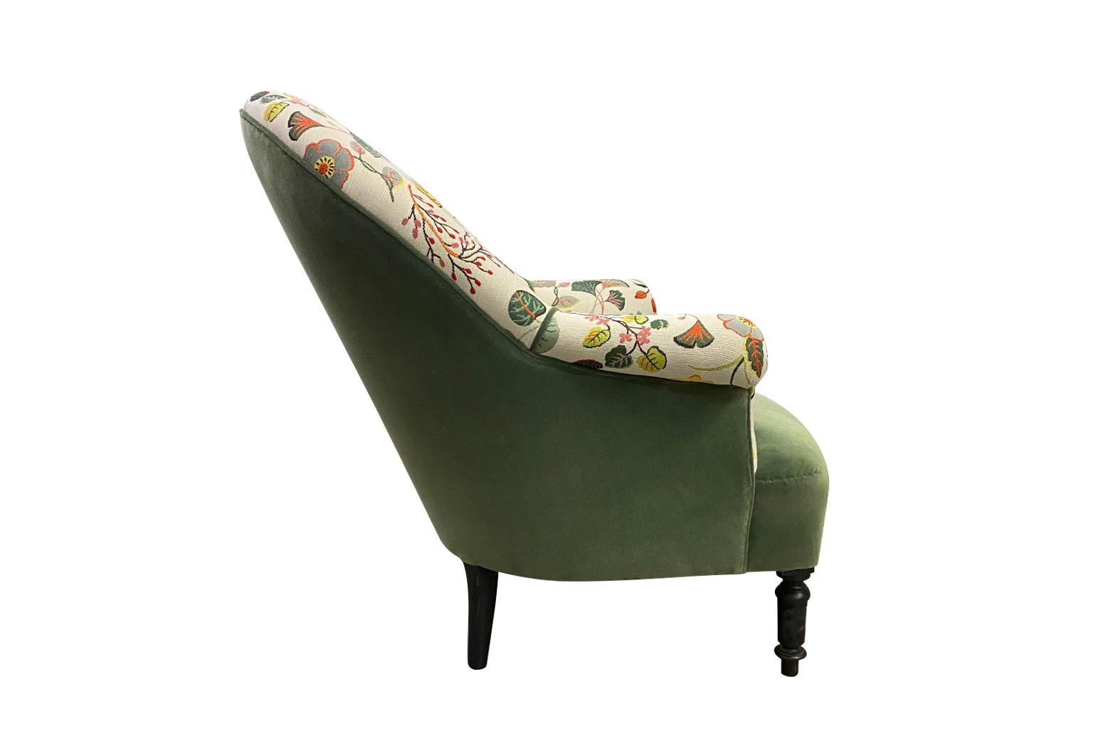 French curved chair with colorful floral fabric, the seat and back are contrasted in a complimentary green velvet. Original leg finish has not been altered which adds to the character and charm of the piece.