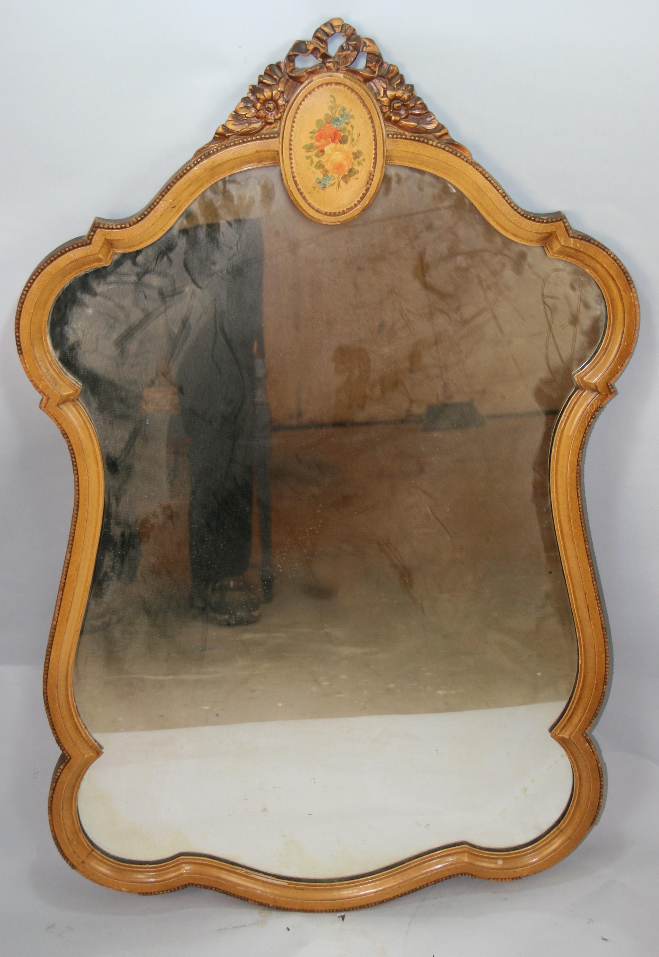 French curved wood mirror with painted flowers.