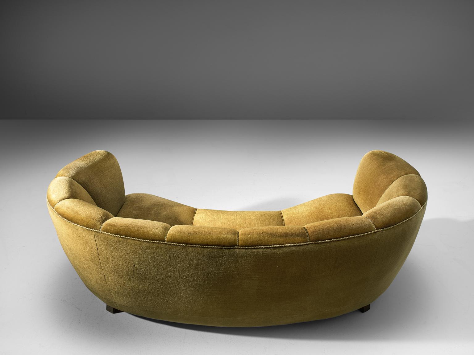 Curved sofa, yellow/green velvet and oak, France, 1950s

This voluptuous sofa is executed with wooden legs and shimmering mustard colored velvet fabric. The sofa has a high webbed, curved back and a very thick body, both the back and armrests are