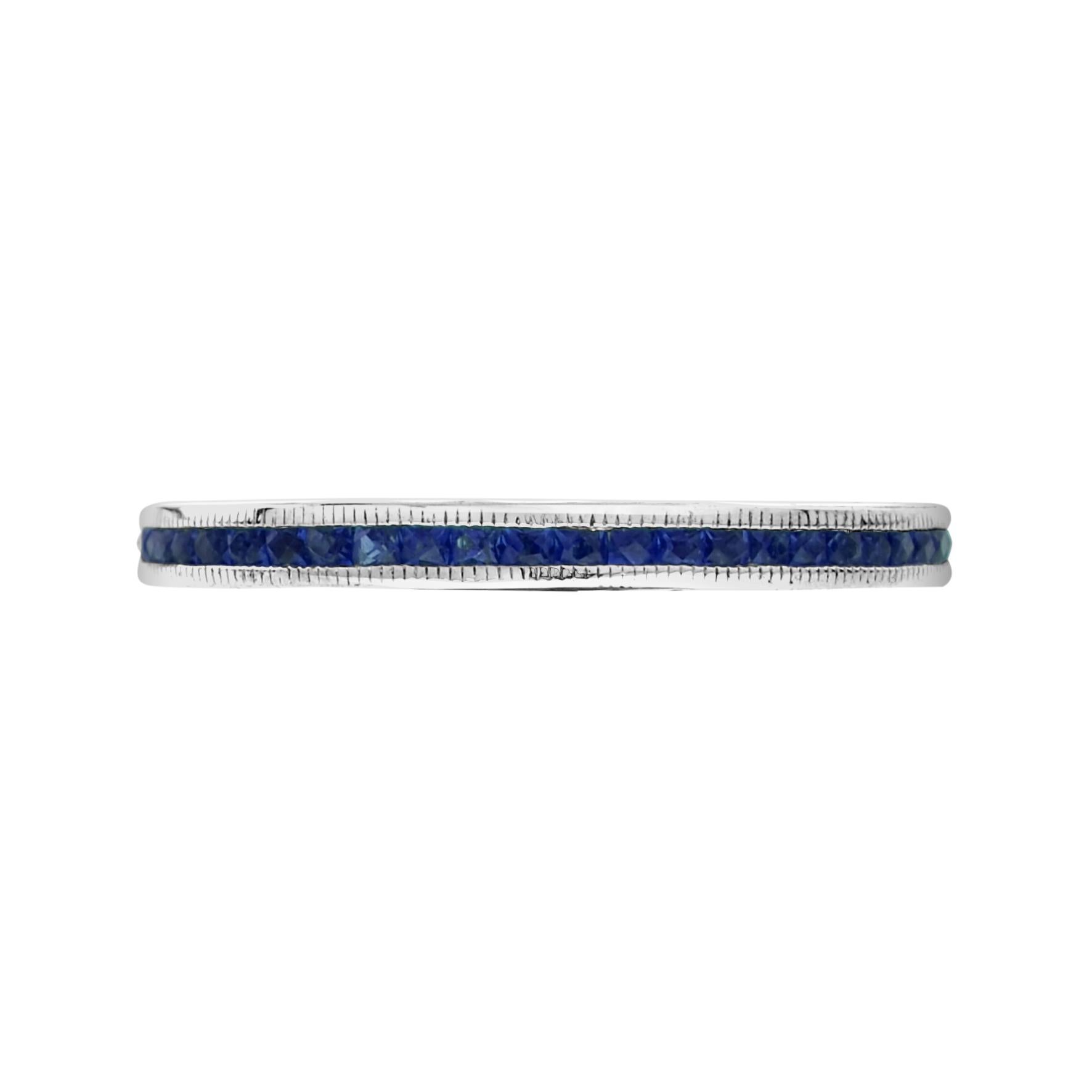 Discover a beautiful and dainty piece of art deco history. The natural French cut sapphires run around the entire ring in an enclosed type of setting. This piece is great for wearing with an antique or vintage engagement ring or stacking with