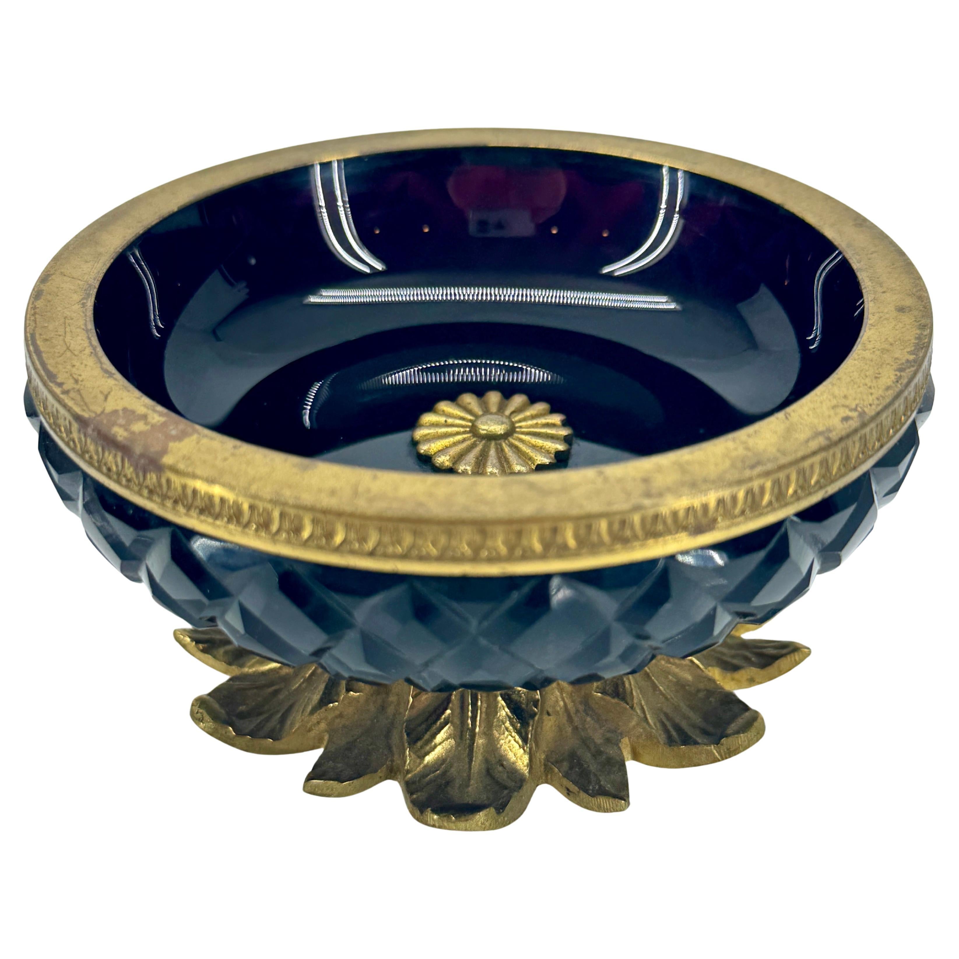 Gilt Bronze and Amethyst Cut Crystal Bowl, France

This classically inspired bowl is decorated with bronze detailing including foliate bronze feet. Versatile piece that can be displayed on a side table sitting alone as decorative or also would make