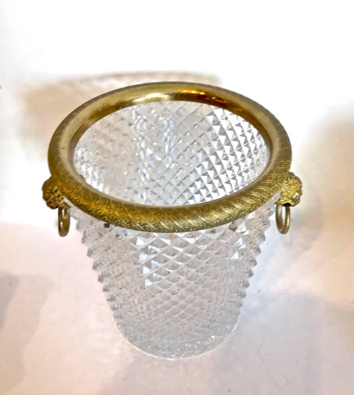 This is a great 20th century French cut crystal and ormolu ice buckets in the style of Baccarat. This is the second of two identical listed ice buckets. This bucket exhibits more patination to the ormolu than the other listing and has a slightly