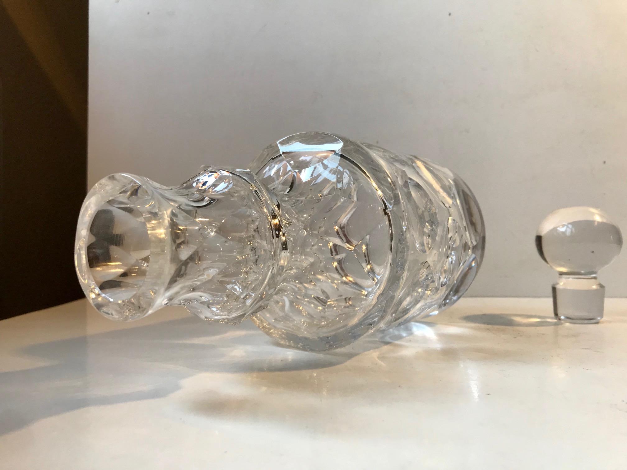 Exceptional decanter executed in lead crystal. Very detailed and intricate craftsmanship to both the dotted bottom part and the faceted neck piece. We know its French. Its is signed to the base by an unidentified glassworker. We suspect its either
