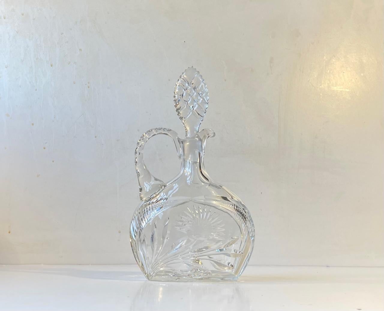 Cristal de Lorraine has an inheritance that goes back all the way to 1764. They have created crystal ware for names like Hermés, Cartier and St Dupont. This wine decanter dates to the 1950s or 60s. 'No stones are left unturned' and its many cut