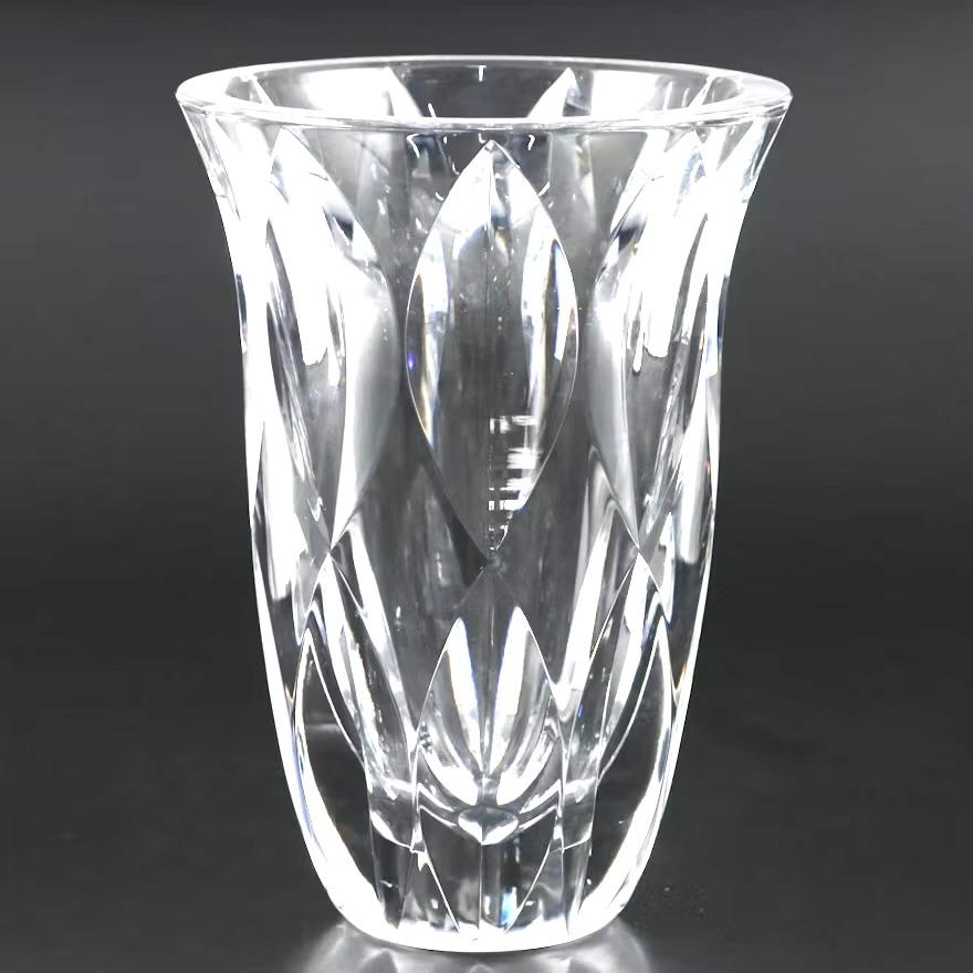 Impressive cut crystal vase by renowned cristallerie Saint Louis Cristal manufacturers  handicraft in Saint-Louis-lès-Bitche, France. Fine mouth blown and hand cut crystal vase with an oval and harlequin pattern that comes together at the base